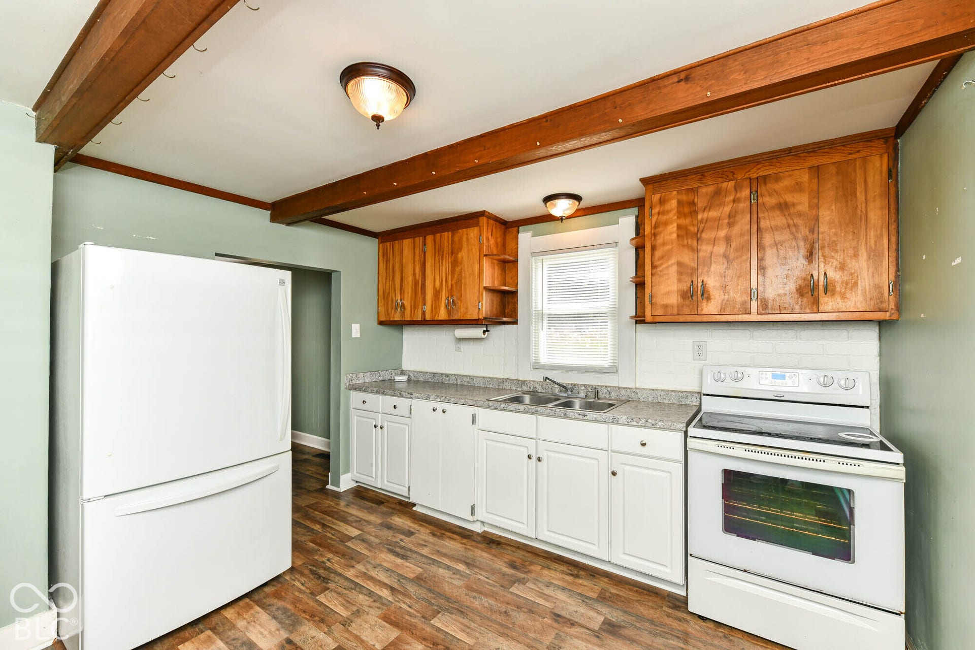 896 Young Street, Franklin, IN 46131 Kitchen highlights include exposed beams, brick backsplash, large refrigerator.