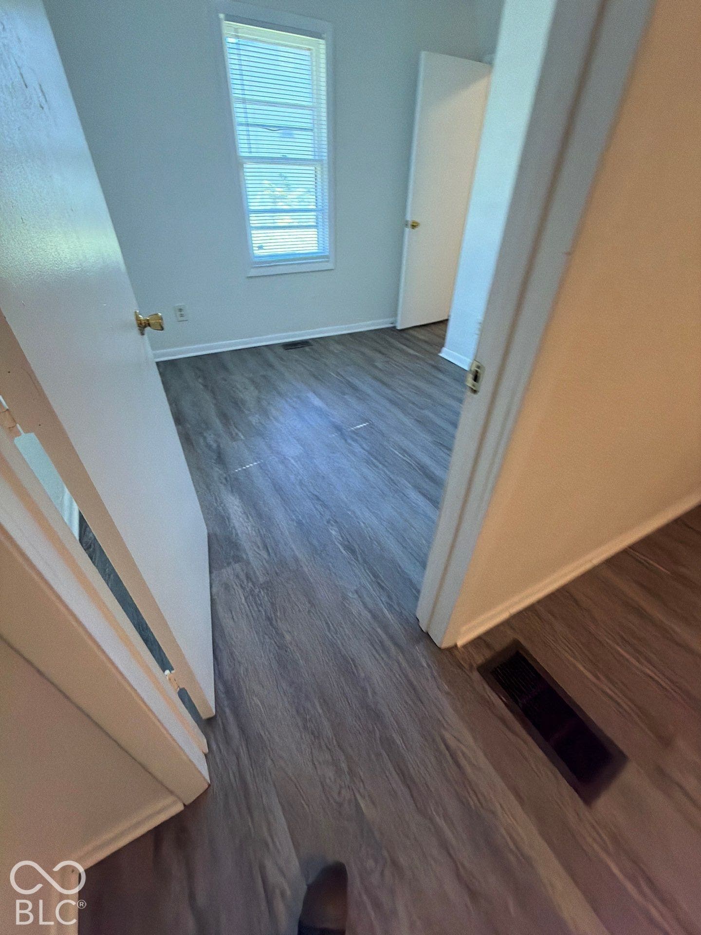 Wood-finish flooring with crisp white walls and trim