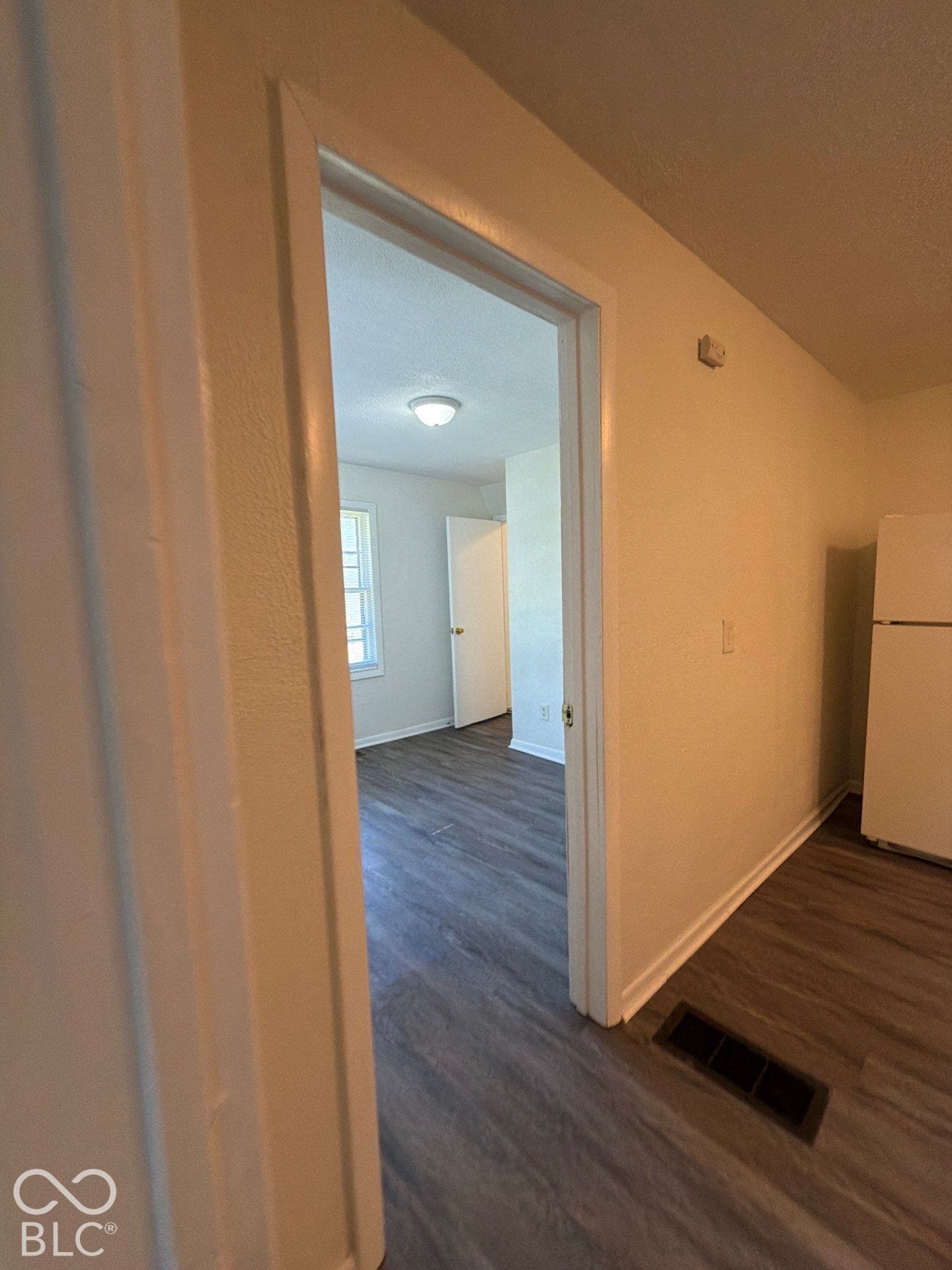 Wood-finish flooring throughout, white interior doors, and recessed ceiling lighting