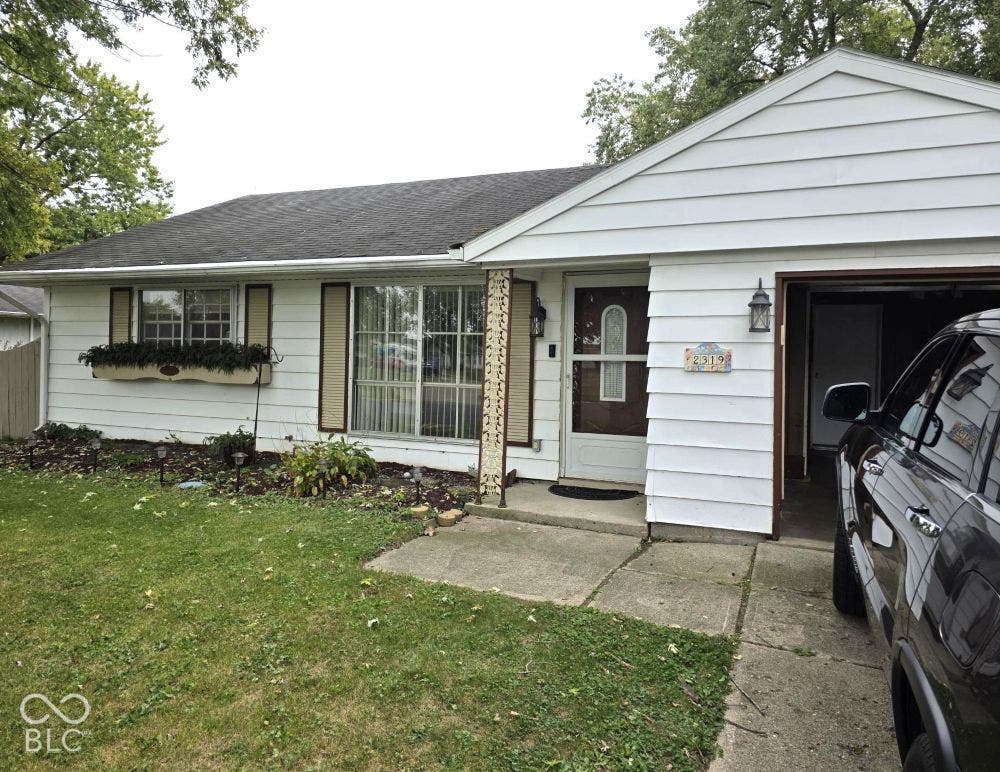 White siding exterior with a dark shingle roof