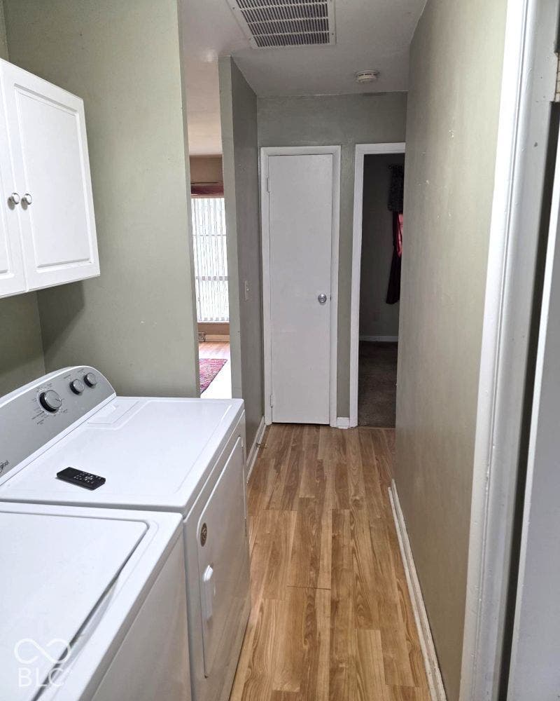 Wood-finish flooring with light-colored walls and white trim