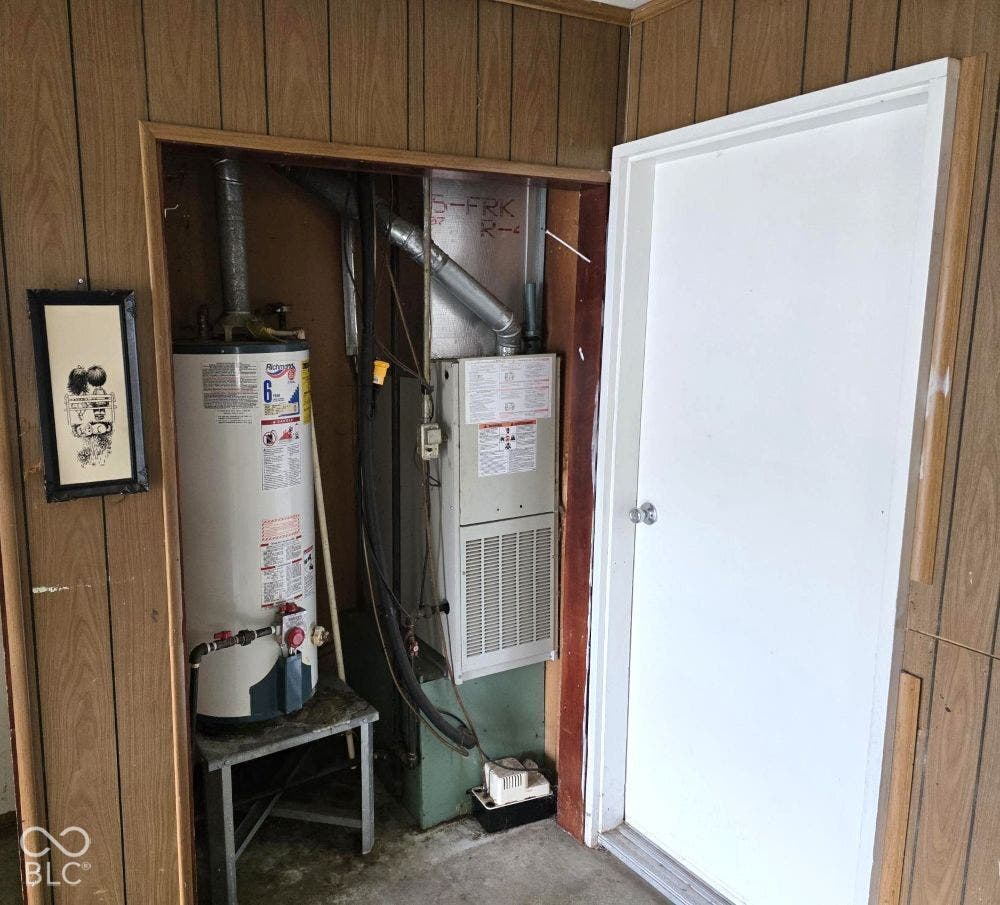 The utiliity closet at the back left corner of the garage.