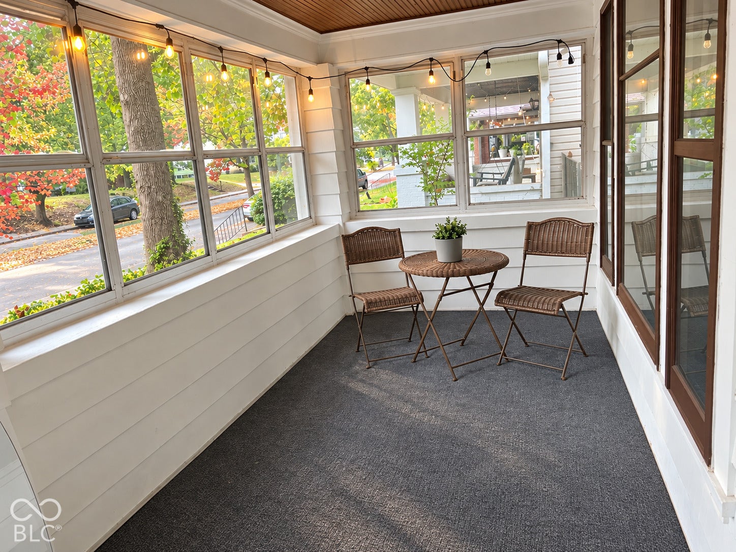 Enclosed porch featuring wrap-around windows, horizontal lap siding, and a finished wood-paneled ceiling