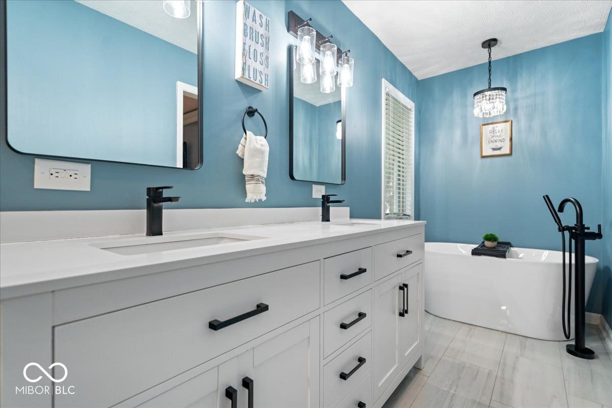 Renovated primary bathroom with soaking tub and walk in shower.