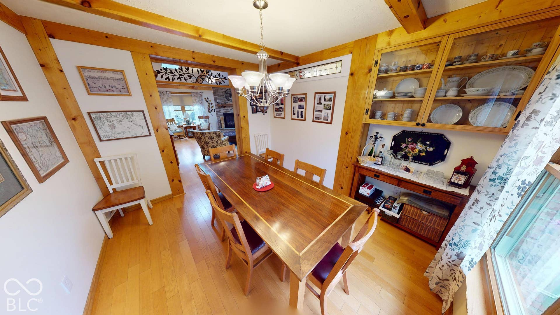 Wood-finish flooring with exposed wood beams and trim