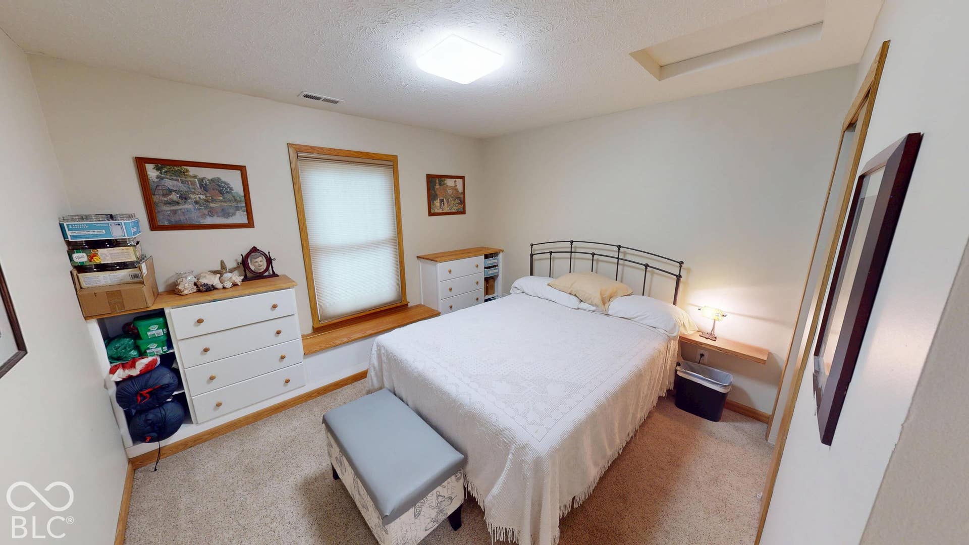 Bedroom #2 =Window with wood trim, built-in shelving, and carpet flooring