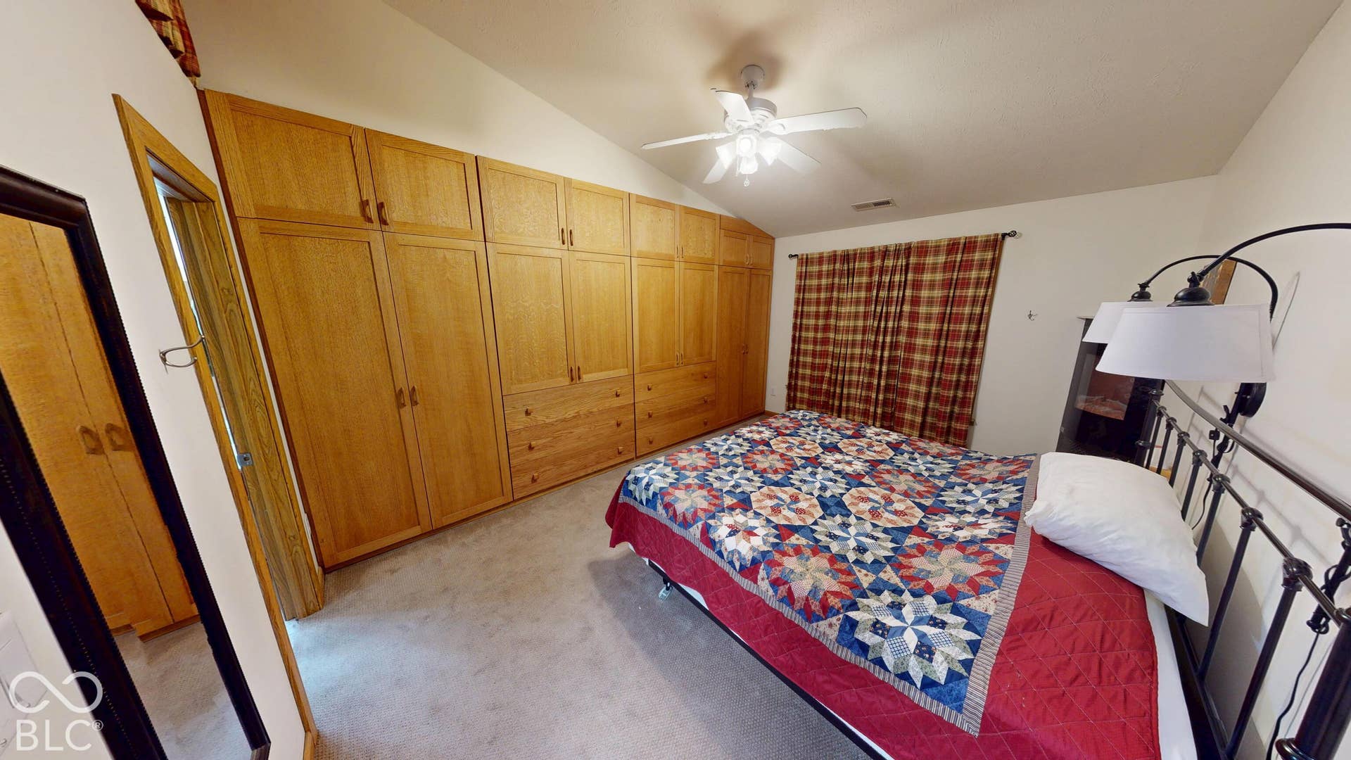 Bedroom #3 Varnished wood-finish built-in cabinetry and drawers, vaulted ceiling, and overhead ceiling fan