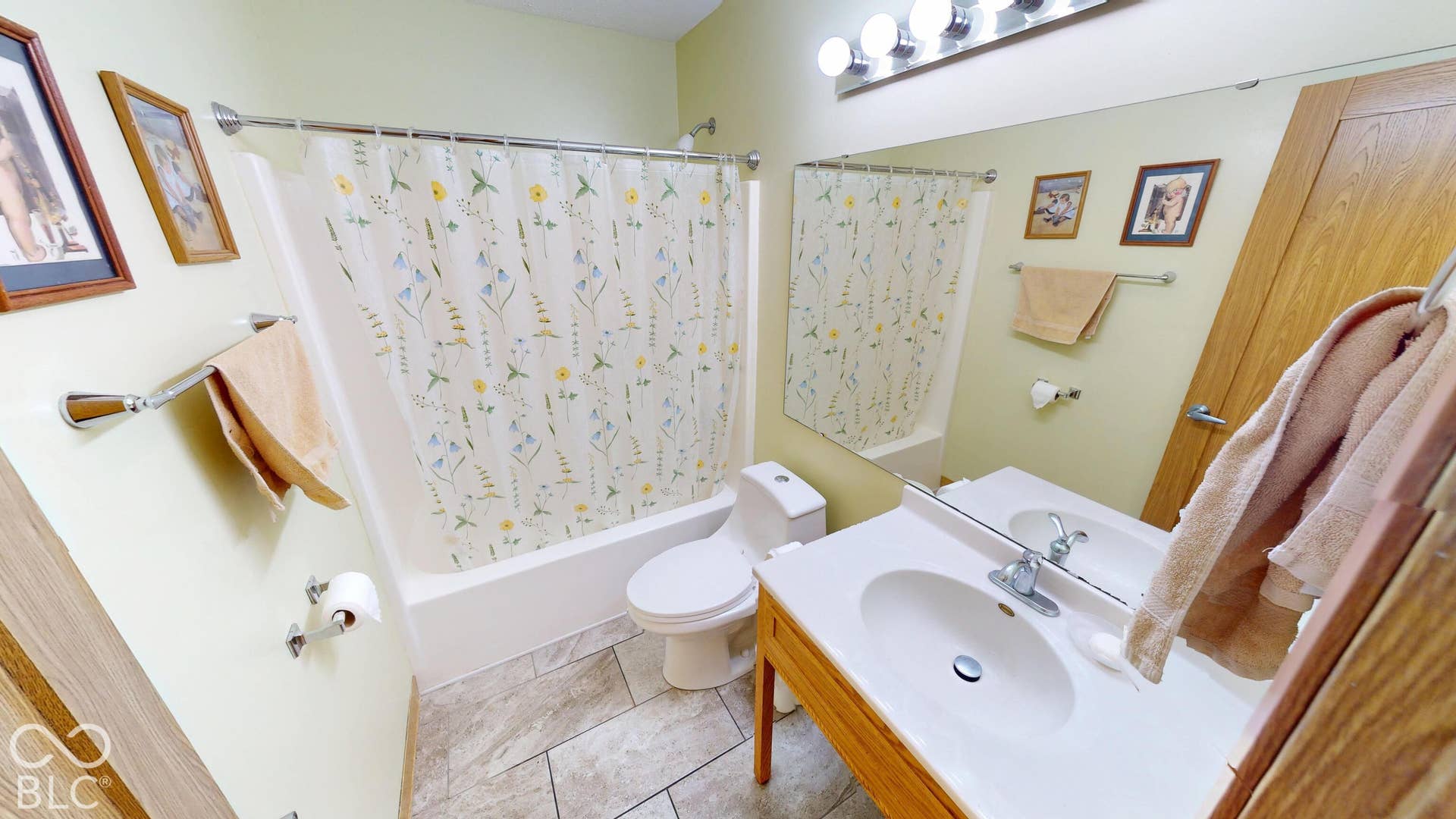 Vanity with integrated sink, chrome faucet, and expansive mirror