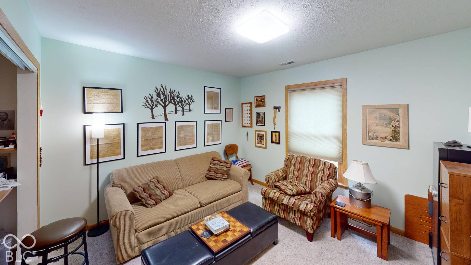 Bedroom # 1 - Currently used as a extra living room/sitting space. But is a bedroom with a large closet. Recessed lighting and a window with wood-trim