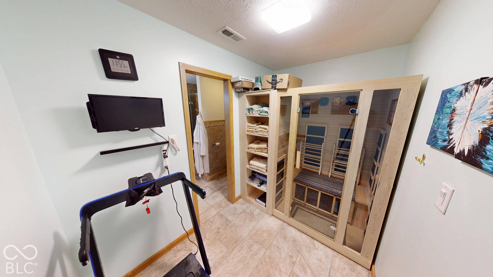 Built-in sauna with a glass-paneled door, recessed lighting, and tile flooring