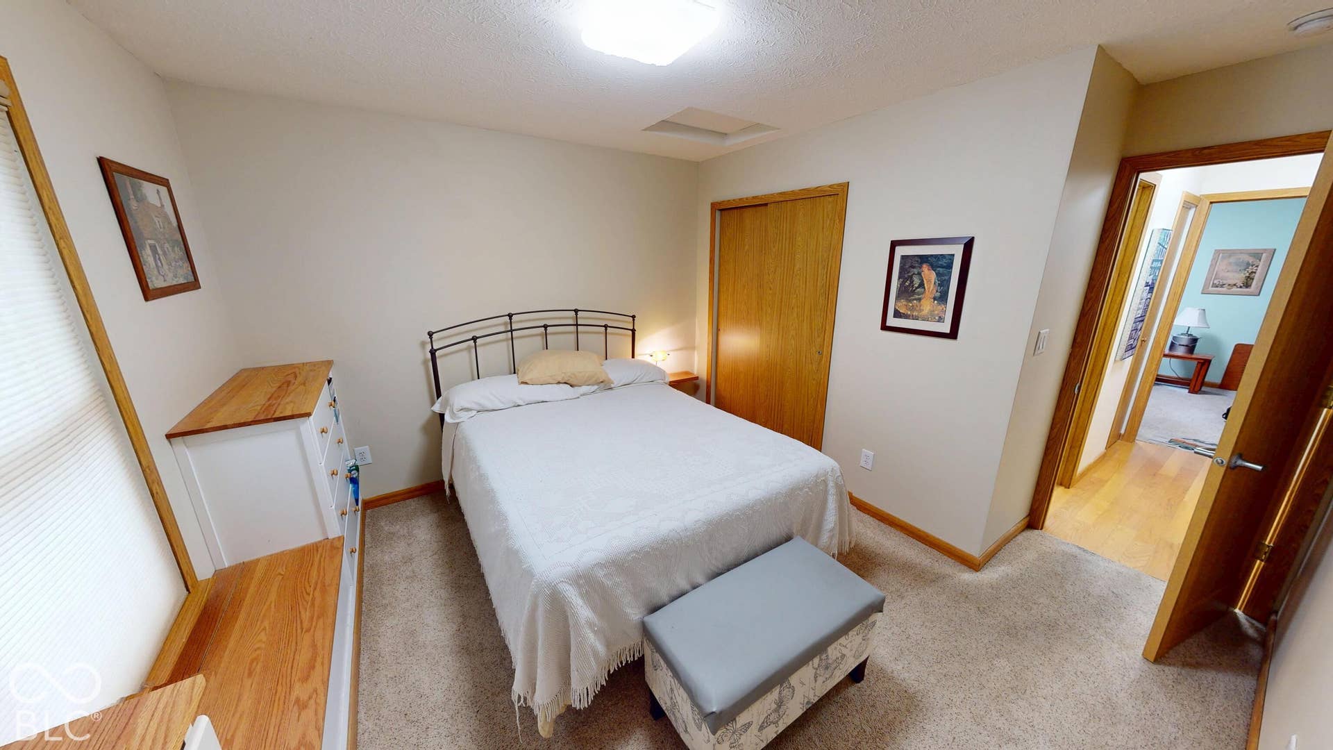 Bedroom #2 =Carpeted flooring, light-toned walls, and a wood-finish interior door