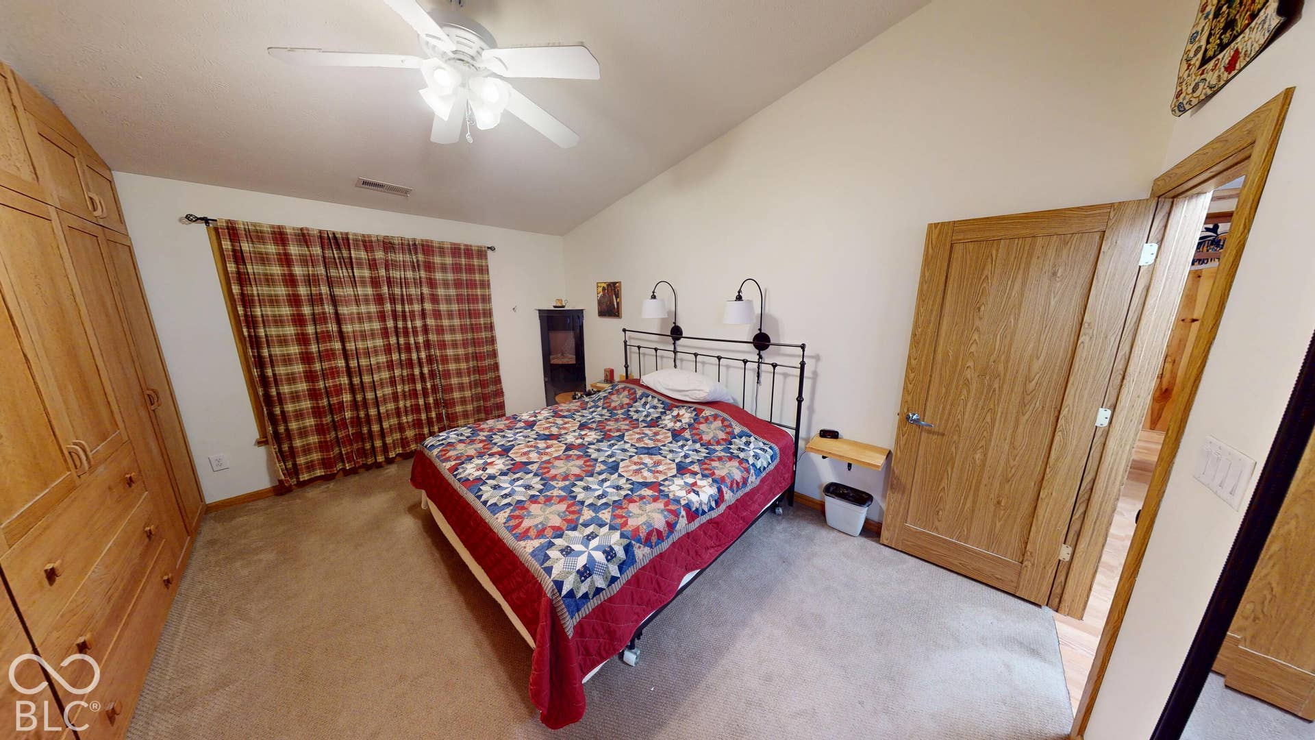 Bedroom #3 Sloped ceiling, ceiling fan, wood-finish doors, built-in wood-finish cabinetry, and neutral carpeting