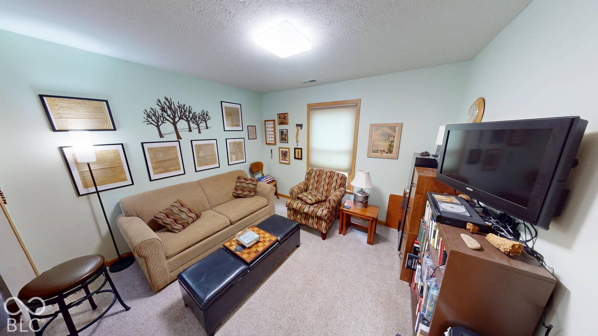 Bedroom # 1 - Currently used as an extra living room/sitting space. But is a bedroom with a large closet. Recessed lighting and a window with wood-trim