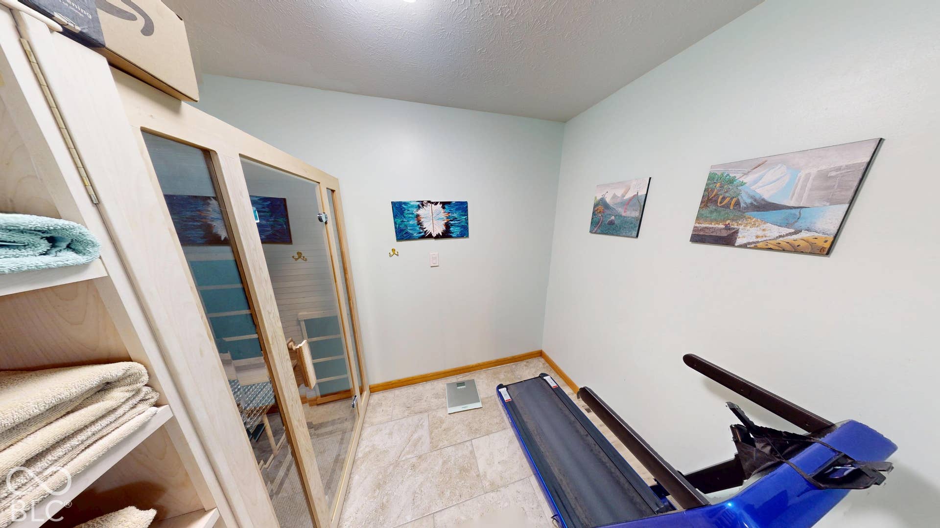 Built-in sauna with glass panel door and light wood frame