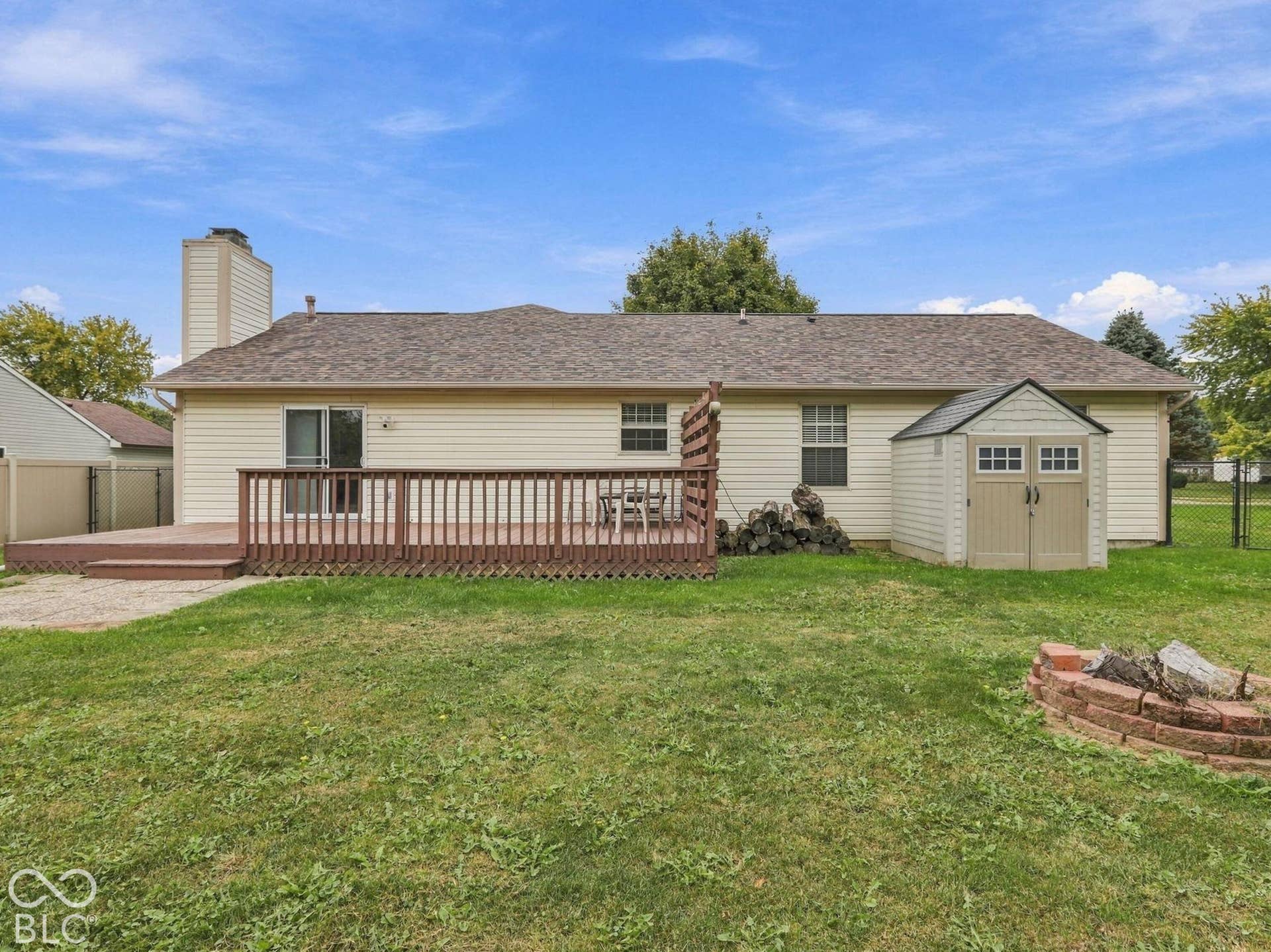 Back yard offers deck, small patio, wood burning firepit and storage shed