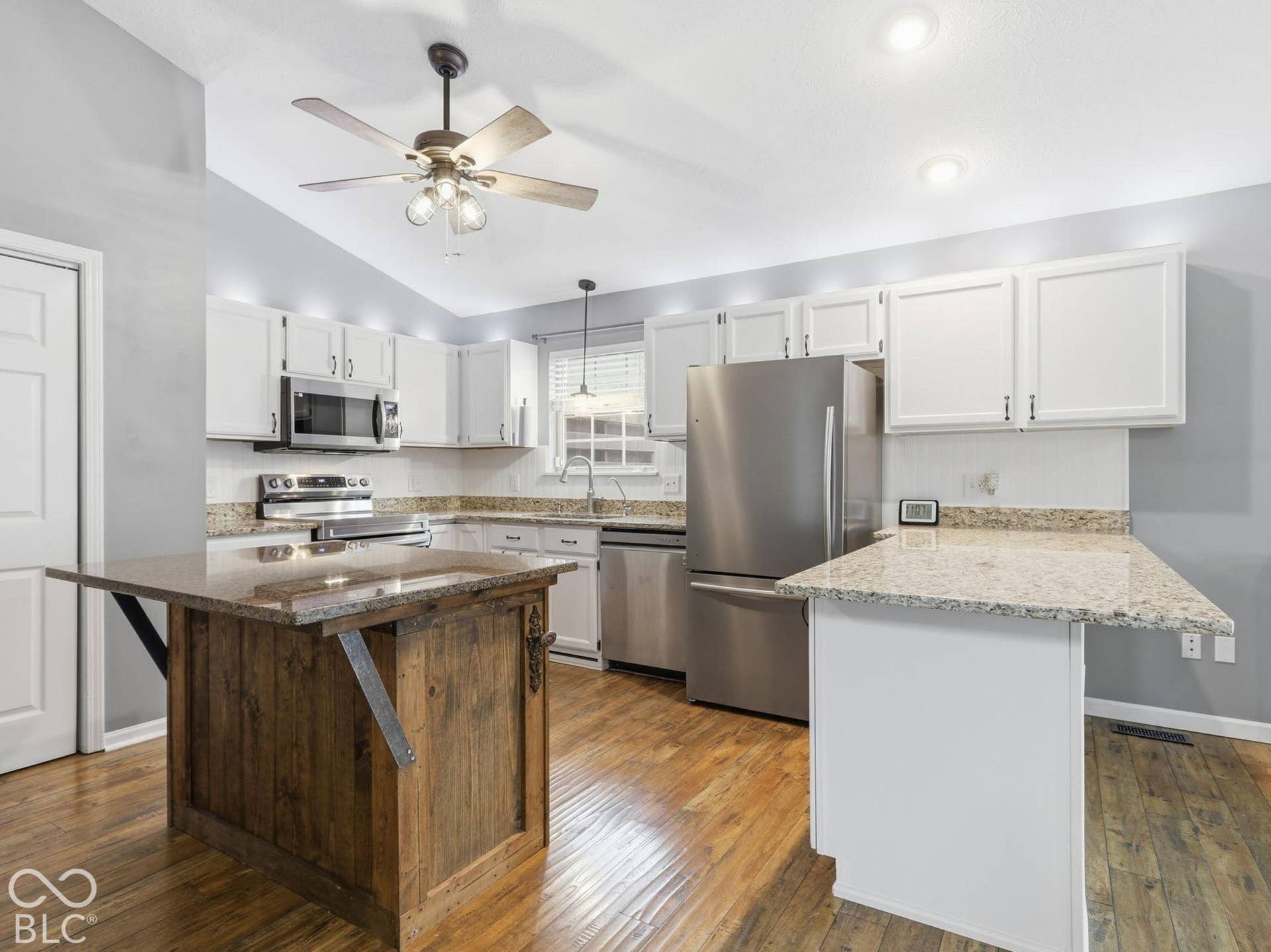 The kitchen has added cabinetry and new stainless-steel appliances
