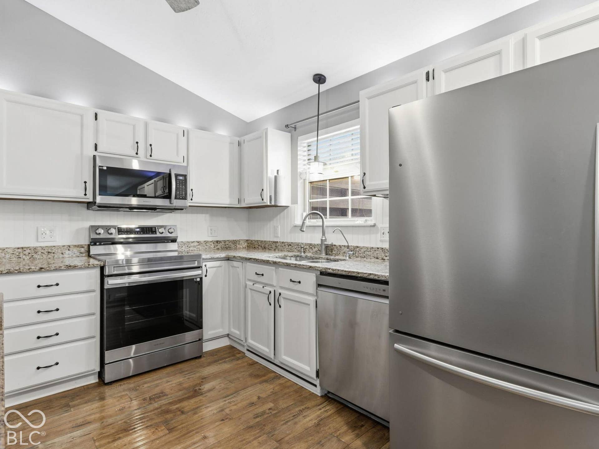 The kitchen is bright and open, with above cabinet lighting