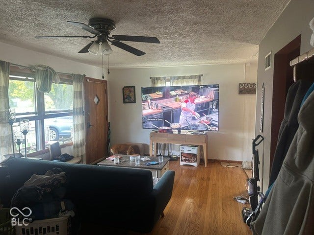 1832 Bauer, Indianapolis, IN 46218 Living area featuring wood-finish flooring, a ceiling fan with integrated lighting, and a multi-pane window