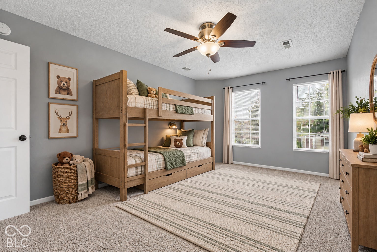 Virtually Altered - Neutral-toned interior featuring carpeted flooring, two double-hung windows, and a multi-blade ceiling fan with integrated light fixture