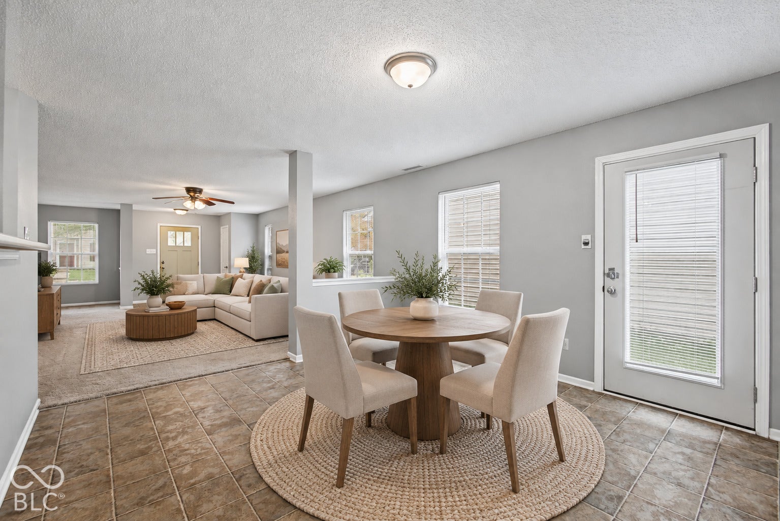 Virtually Altered - Tile flooring, neutral wall tones, multi-pane windows, flush-mount lighting, and an exterior door featuring an integrated window