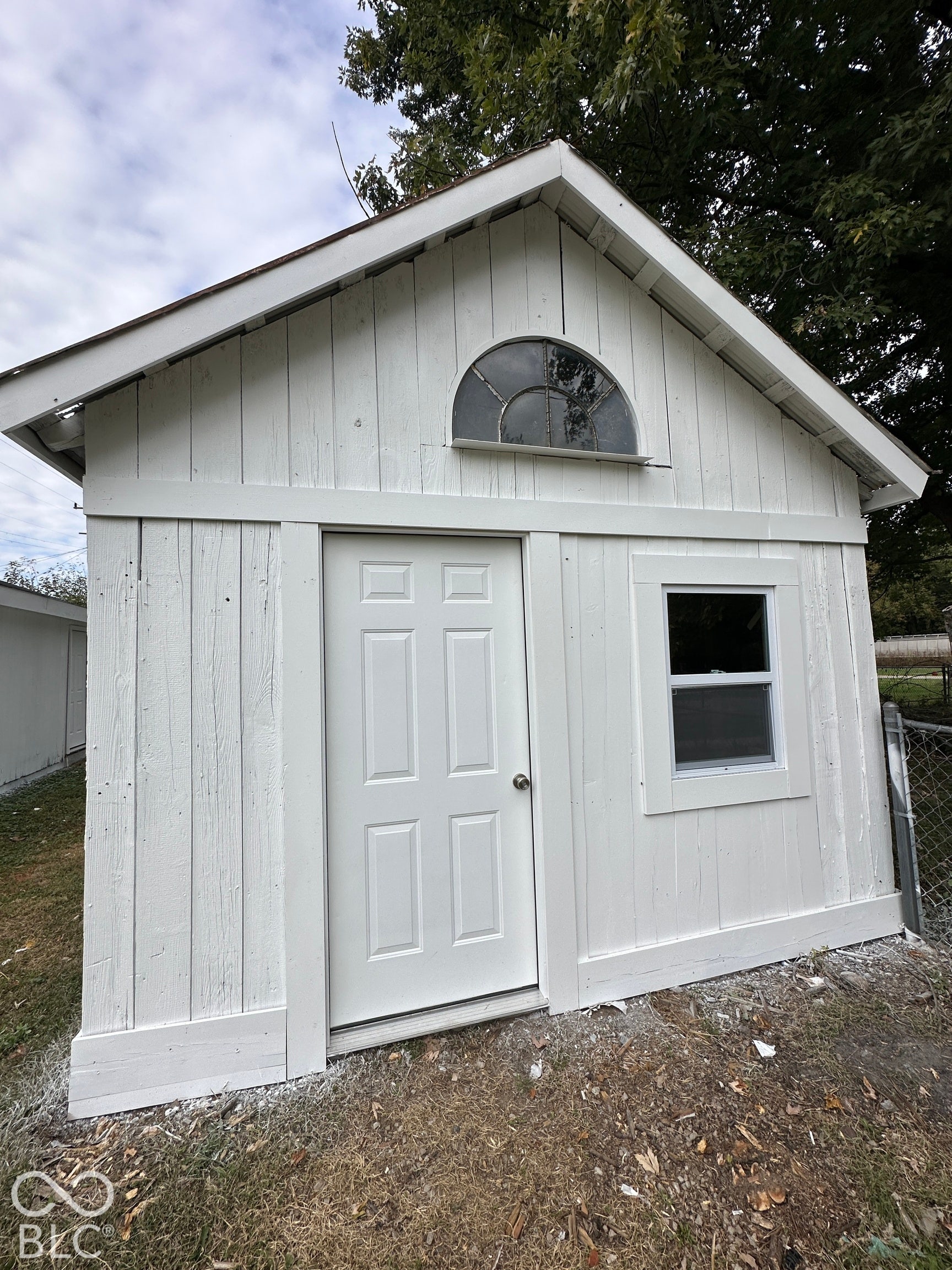 White painted board-and-batten siding with white trim