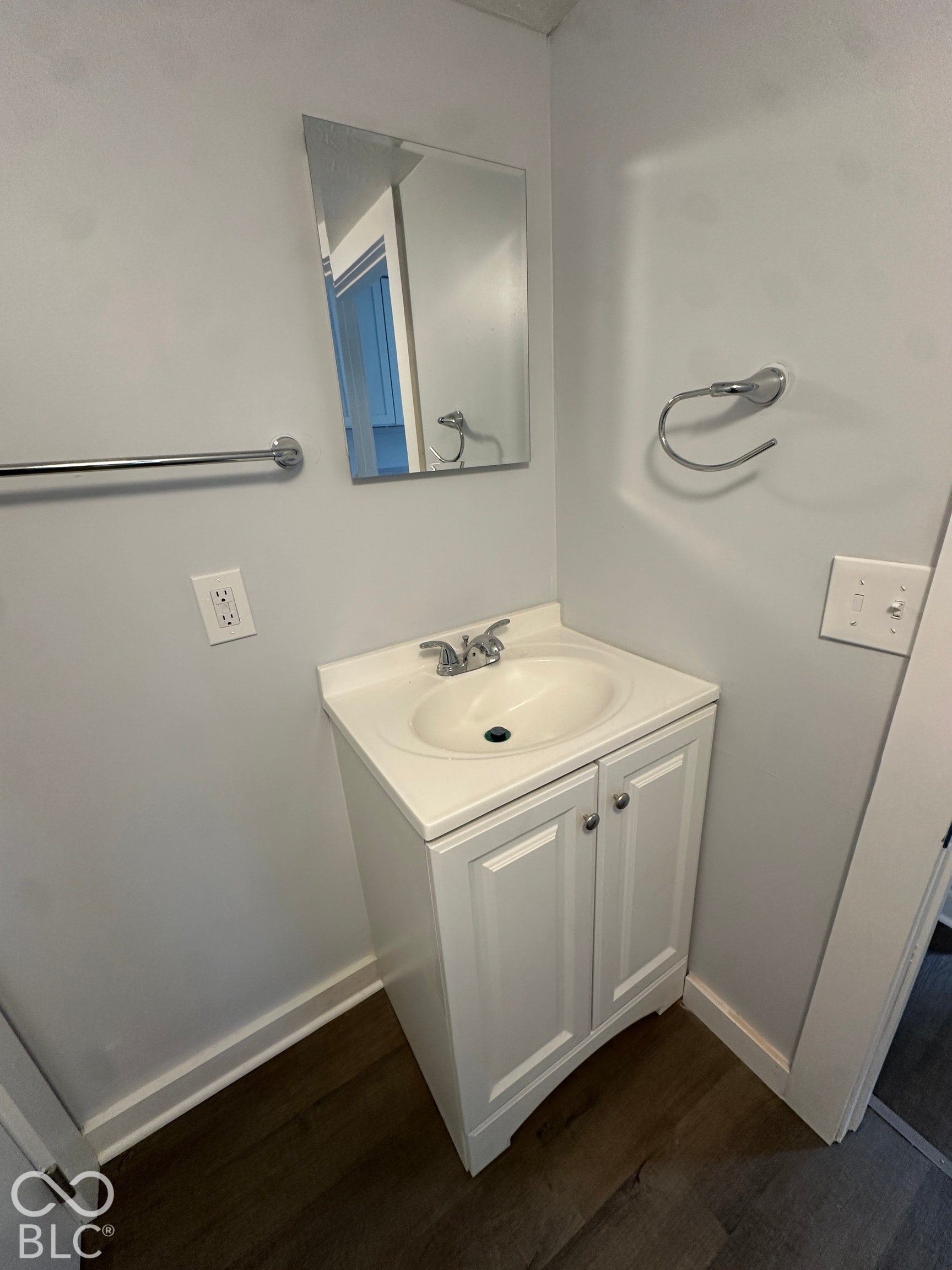 White vanity with an integrated sink and chrome fixtures