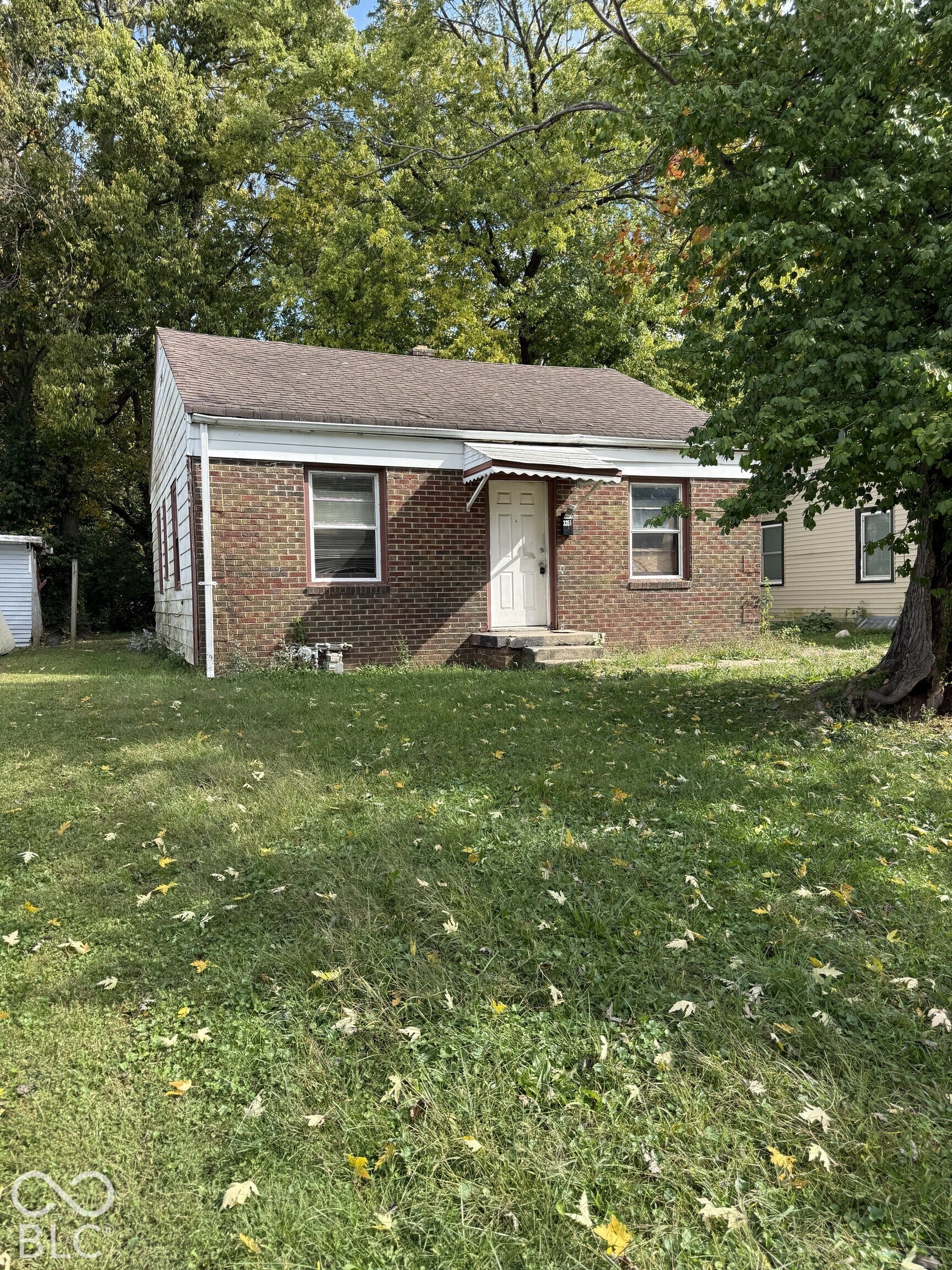 3351 N Grant Avenue, Indianapolis, IN 46218 Brick exterior with a gabled roof and metal front door awning