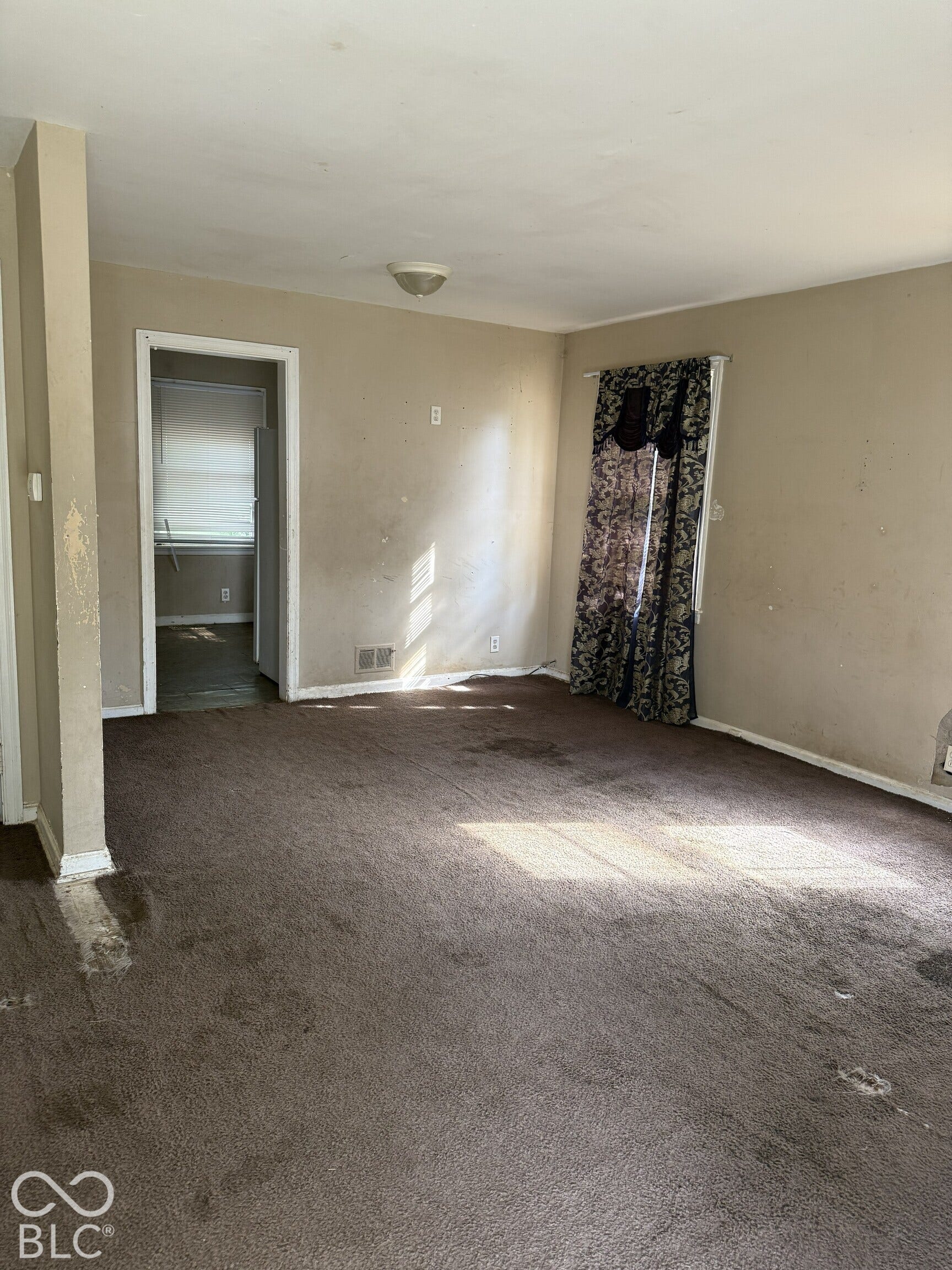 3351 N Grant Avenue, Indianapolis, IN 46218 Interior space featuring neutral wall paint, carpeted flooring, and a flush-mount ceiling light fixture