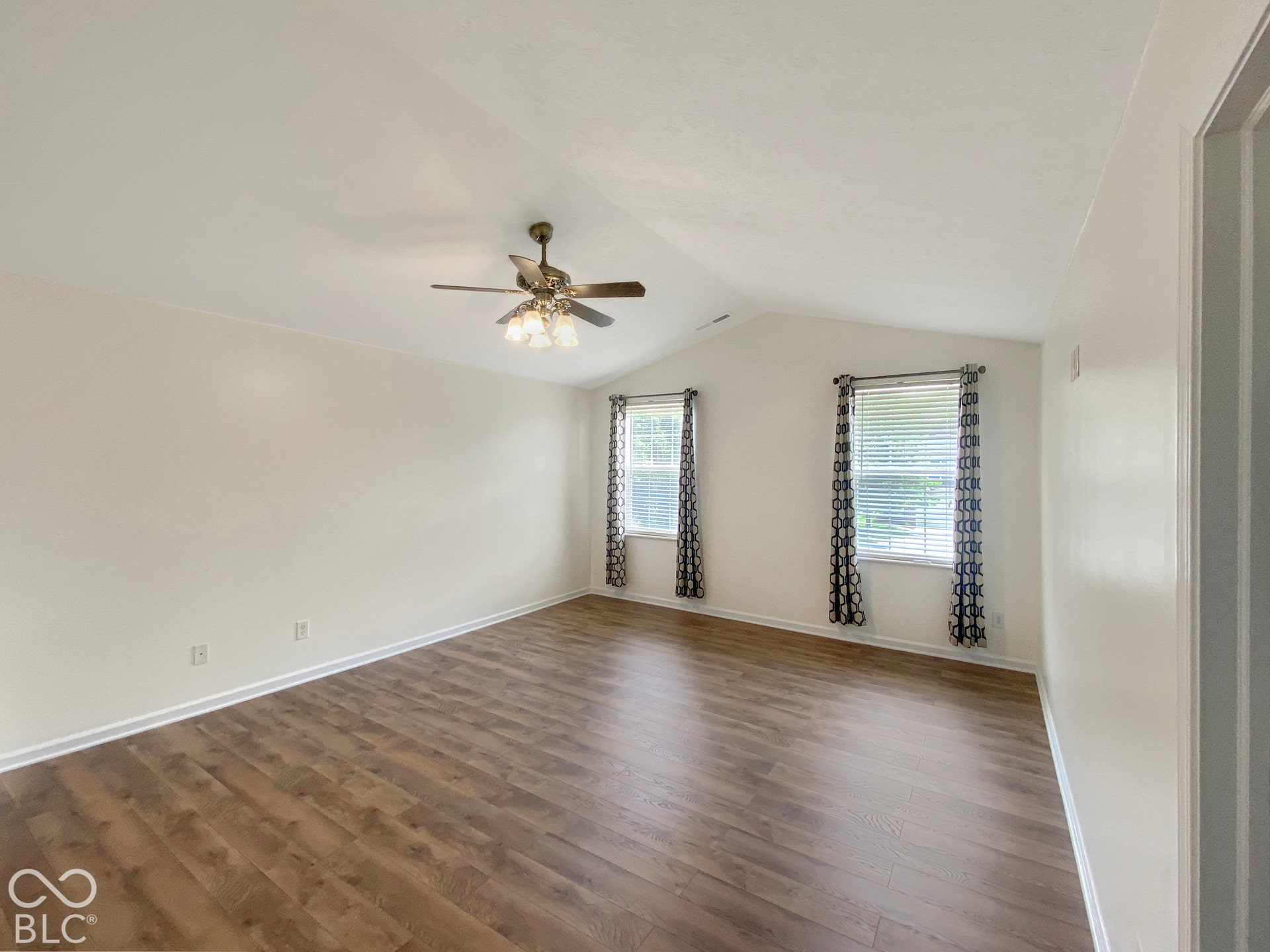 4726 Eva Court, Indianapolis, IN 46227 Vaulted ceiling with a central multi-light ceiling fan and wood-finish flooring