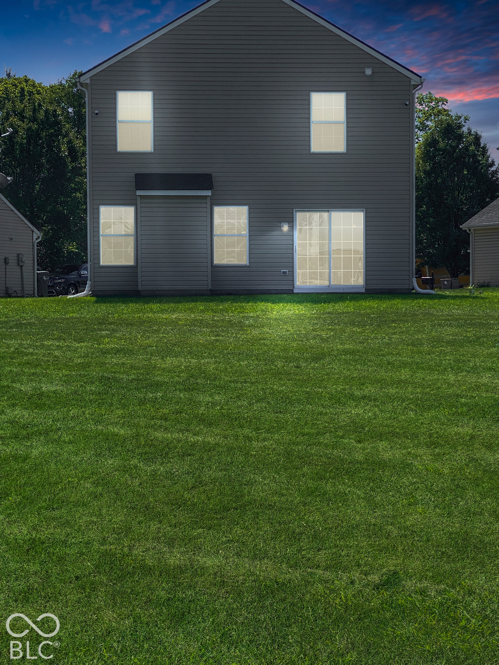 4726 Eva Court, Indianapolis, IN 46227 Virtually Altered - Two-story home with horizontal siding, a sliding glass door, and a grass-covered backyard