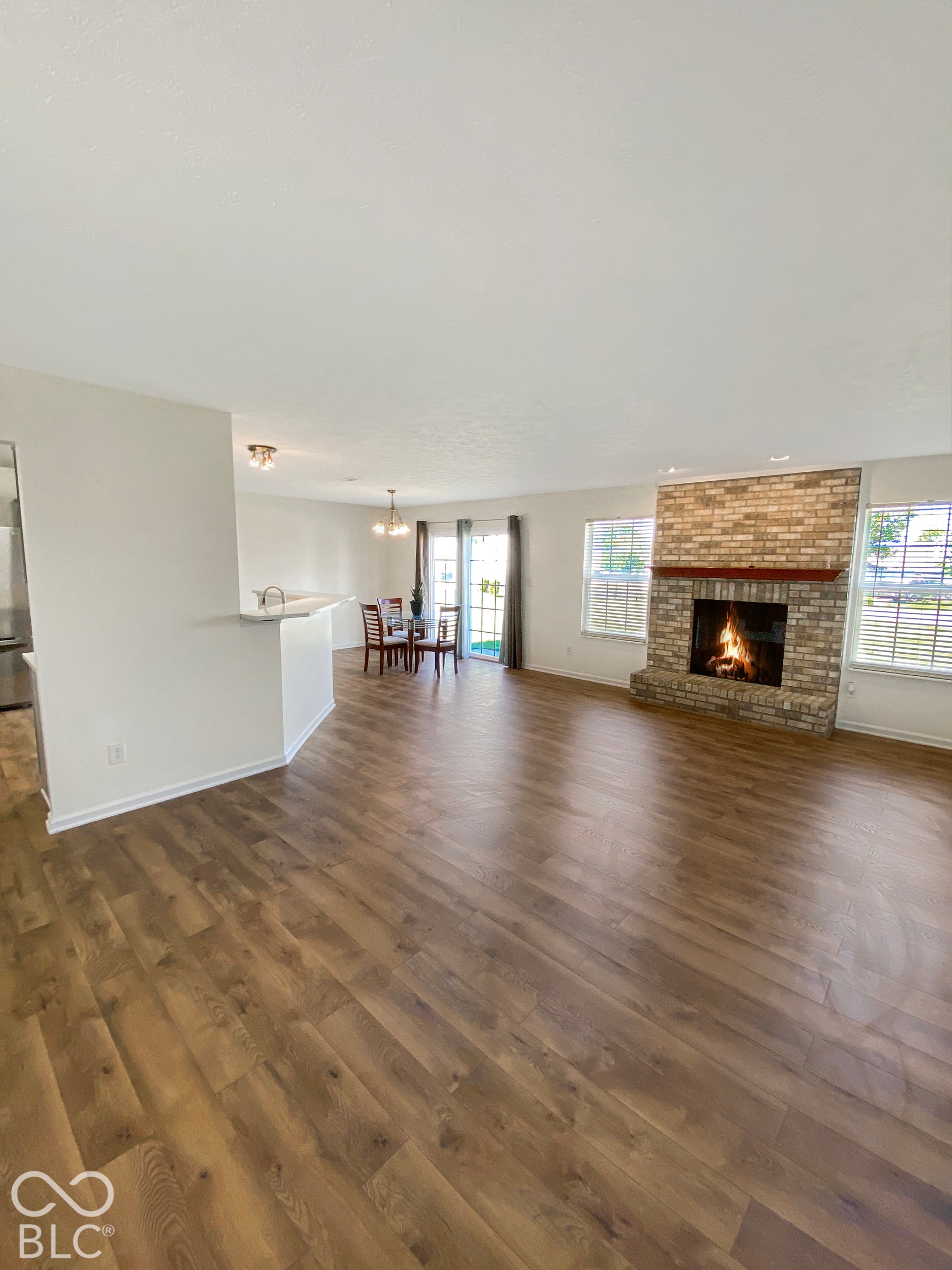 4726 Eva Court, Indianapolis, IN 46227 Wood-finish flooring, masonry fireplace with a timber mantel, breakfast bar, and sliding glass doors