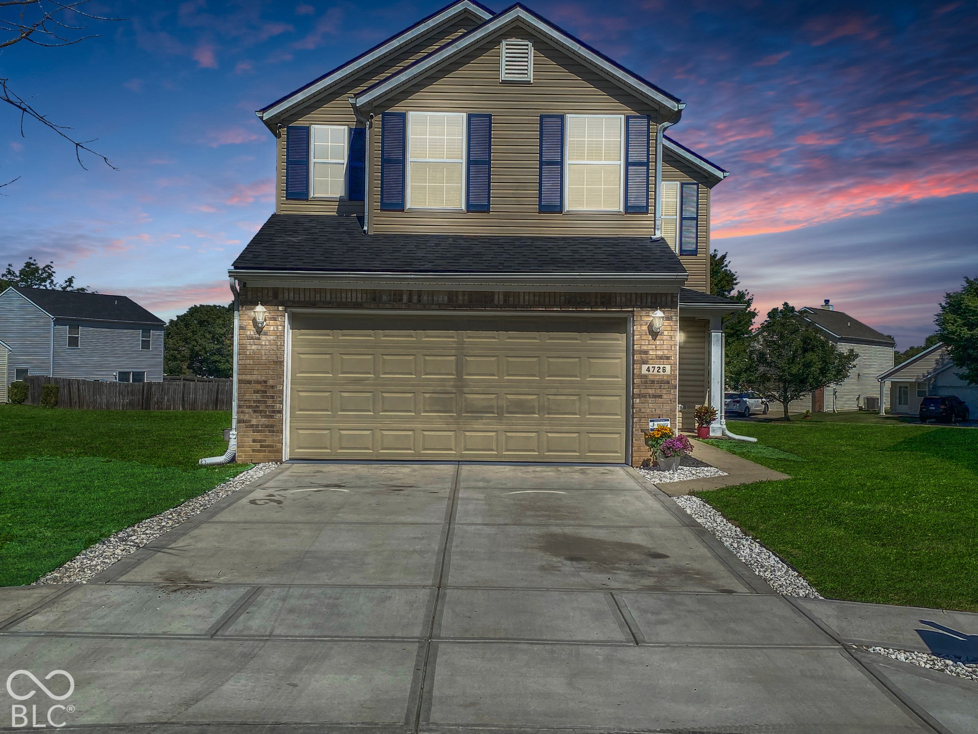 4726 Eva Court, Indianapolis, IN 46227 Virtually Altered - Two-story exterior featuring vinyl siding, brick veneer, decorative shutters, an attached two-car garage, and a concrete driveway