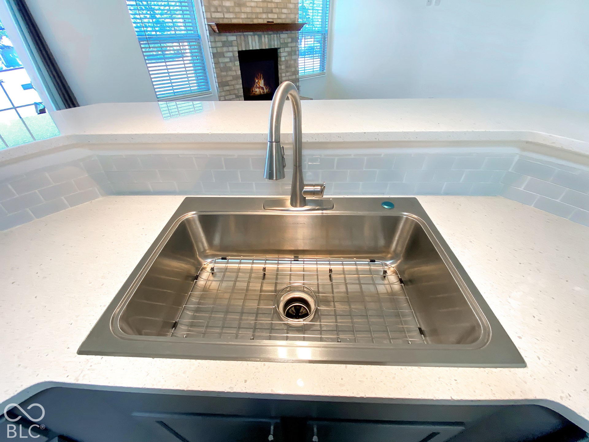 4726 Eva Court, Indianapolis, IN 46227 Stainless steel undermount sink with a gooseneck pull-down faucet, white quartz countertops, light-toned subway tile backsplash, and dark cabinetry
