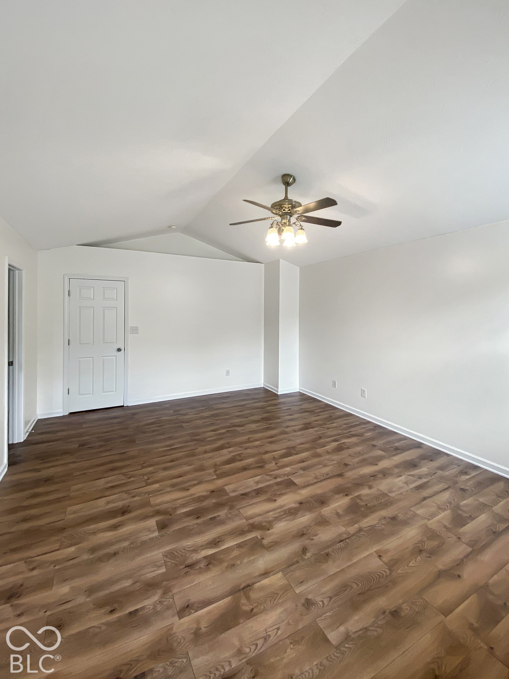 4726 Eva Court, Indianapolis, IN 46227 Vaulted ceiling featuring a central multi-light ceiling fan and wood-finish flooring