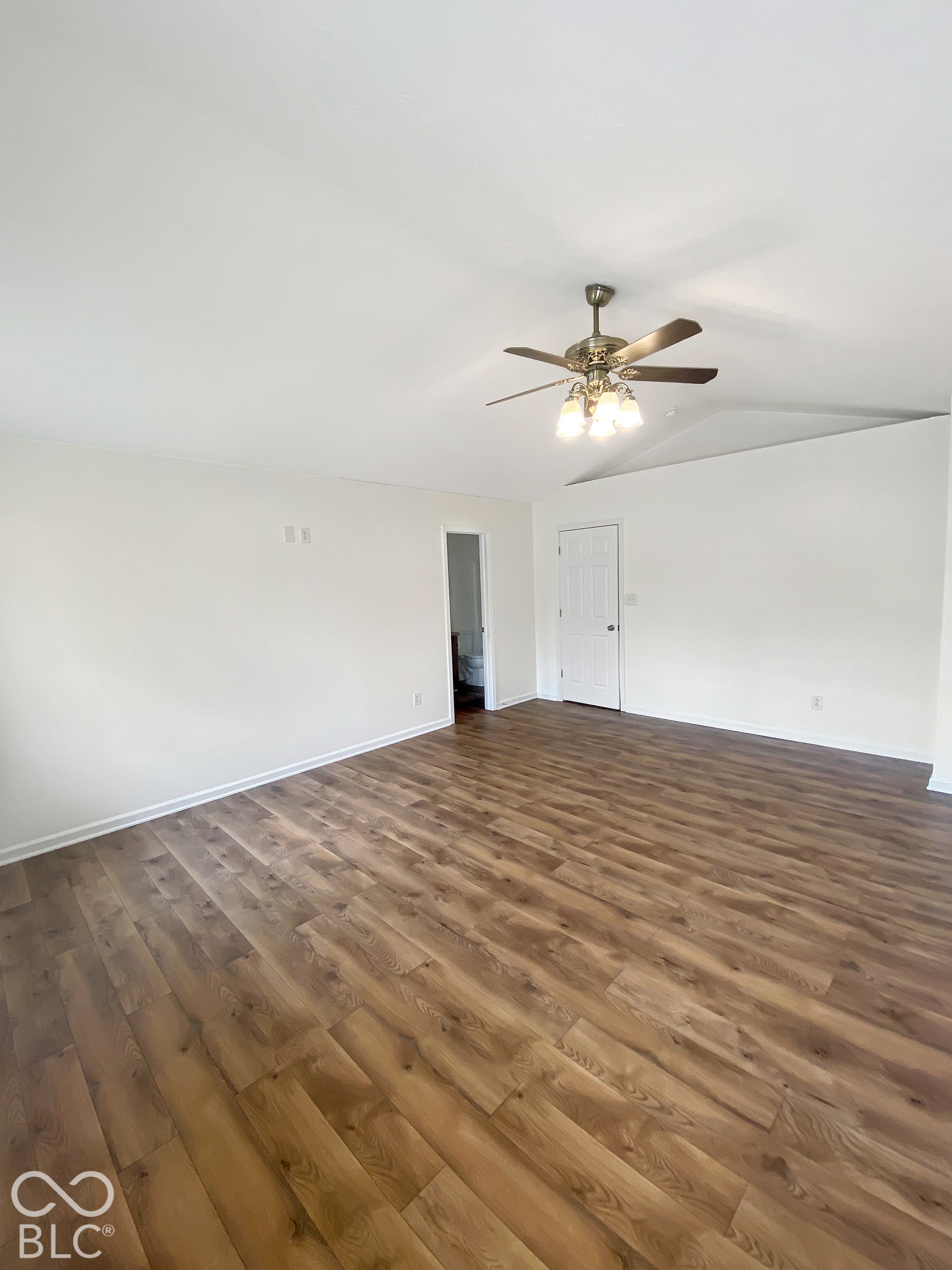 4726 Eva Court, Indianapolis, IN 46227 Vaulted ceilings featuring a central multi-light ceiling fan and wood-finish flooring throughout