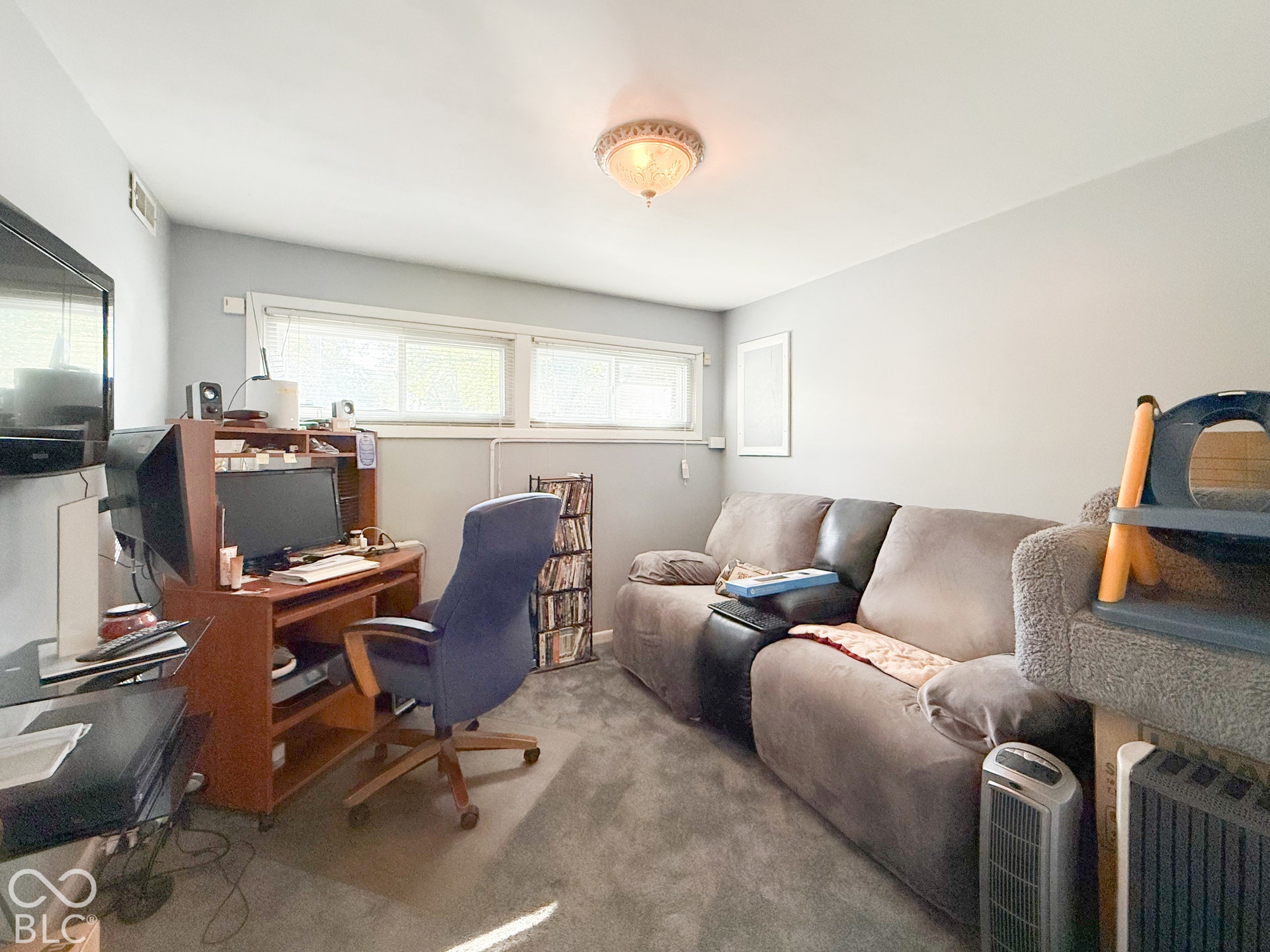 4225 Westbourne Drive, Indianapolis, IN 46205 Interior room featuring wall-to-wall carpeting, two horizontal sliding windows, and a flush-mount overhead light fixture