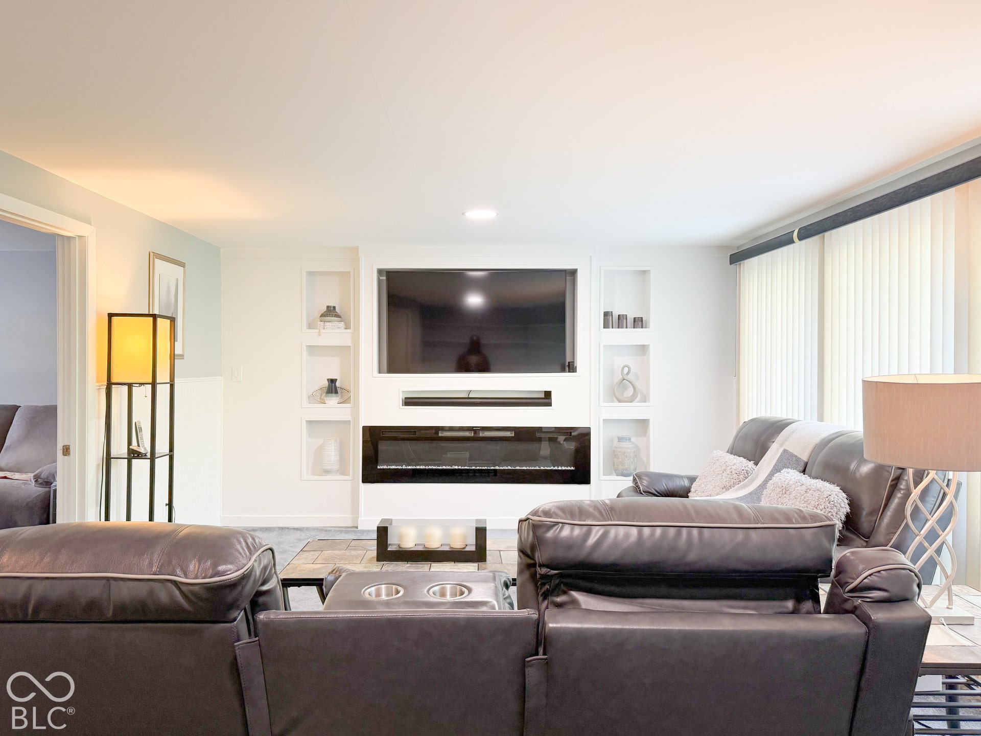 4225 Westbourne Drive, Indianapolis, IN 46205 Built-in media wall featuring a linear electric fireplace, integrated shelving niches, and recessed lighting