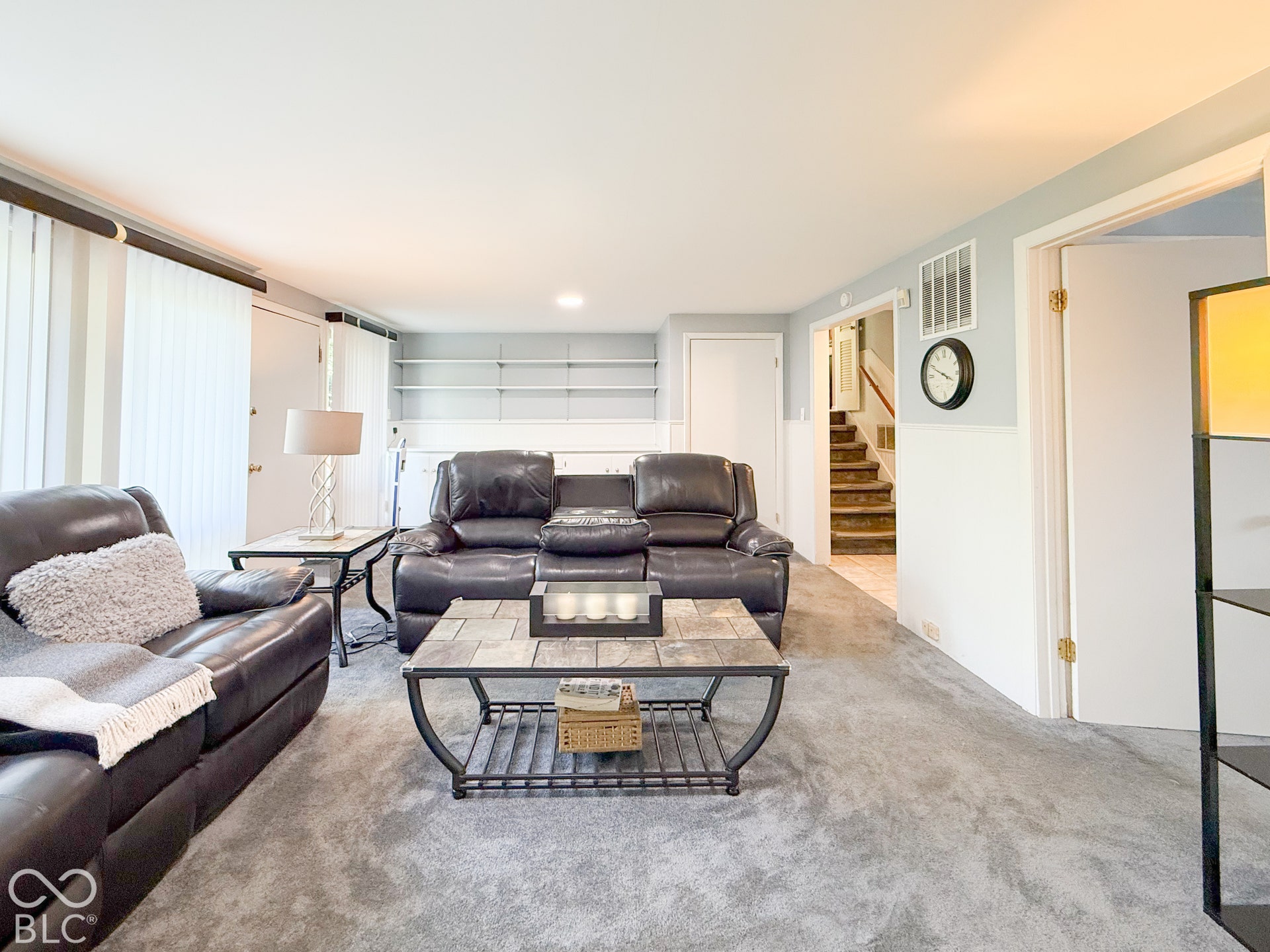 4225 Westbourne Drive, Indianapolis, IN 46205 Interior space featuring neutral wall-to-wall carpeting, wainscoting, and built-in shelving