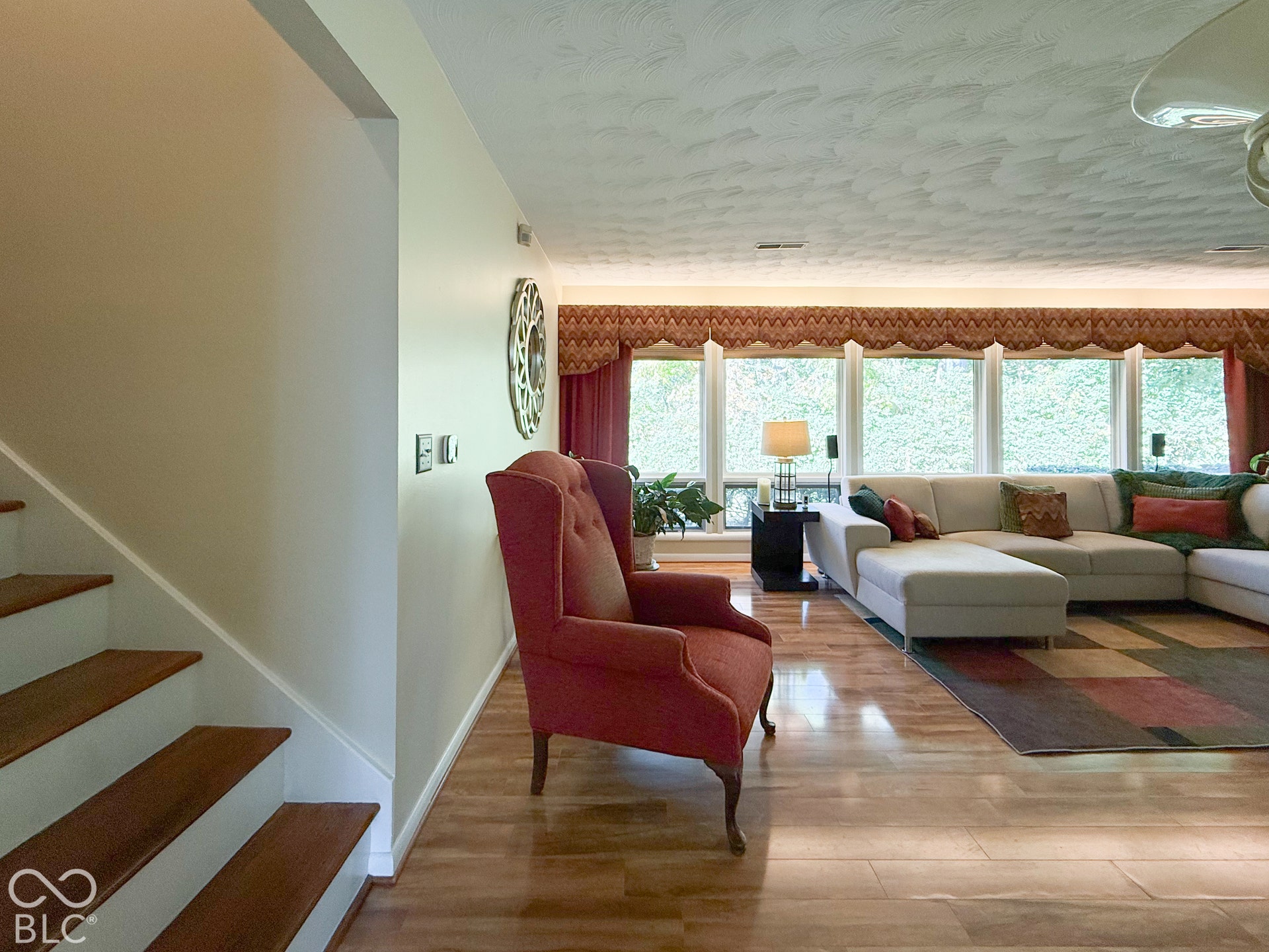 4225 Westbourne Drive, Indianapolis, IN 46205 Open-concept space featuring wood-finish flooring, a textured ceiling, and a large expanse of windows
