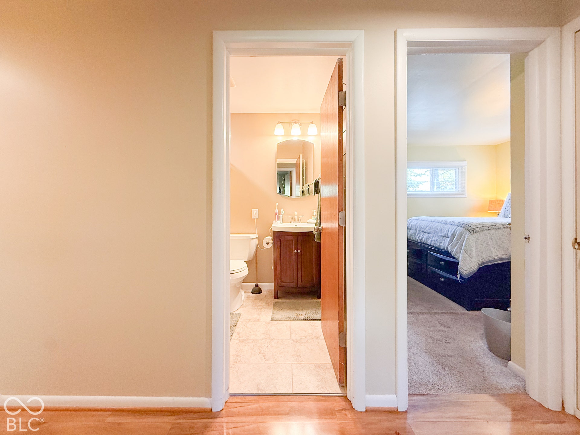 4225 Westbourne Drive, Indianapolis, IN 46205 Bathroom featuring a vanity with wood-finish cabinetry, ceramic tile flooring, and a wall-mounted light fixture