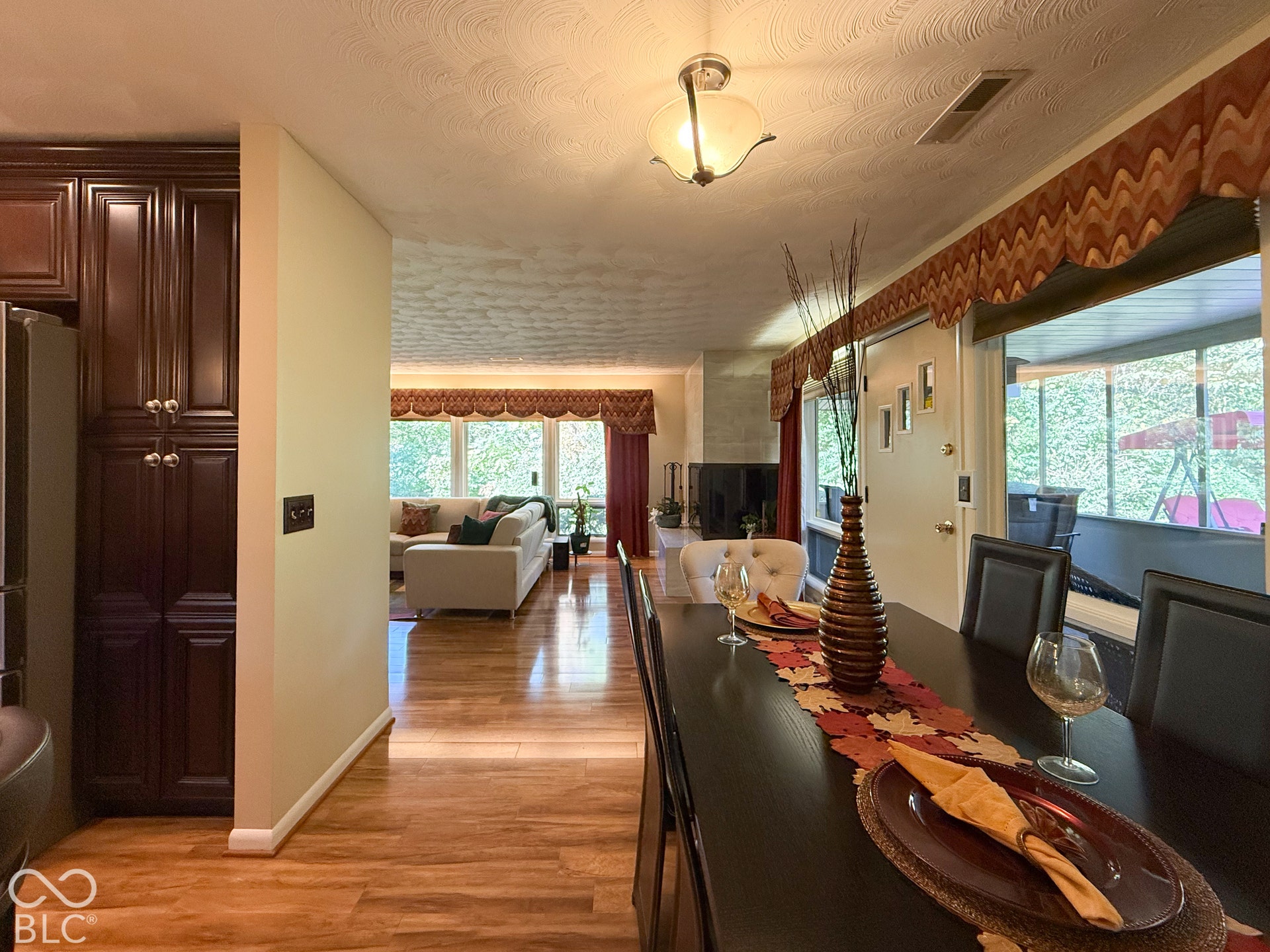4225 Westbourne Drive, Indianapolis, IN 46205 Dark-finish cabinetry, wood-finish flooring, and natural light via floor-to-ceiling windows