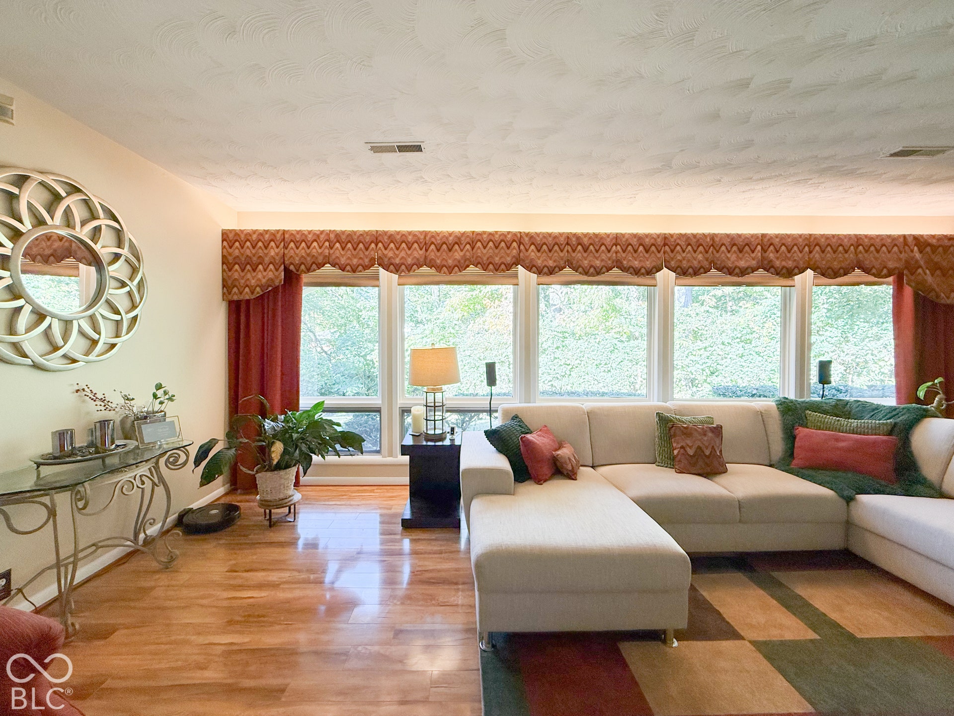 4225 Westbourne Drive, Indianapolis, IN 46205 Living space featuring wood-finish flooring, a wall of expansive windows, and textured ceiling finish