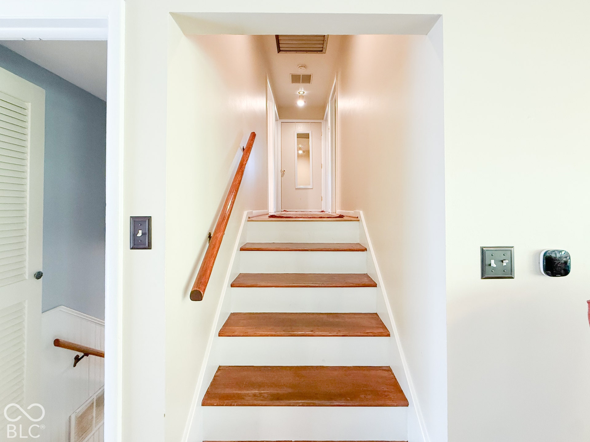 4225 Westbourne Drive, Indianapolis, IN 46205 Staircase featuring wood treads, white risers, and a mounted wooden handrail