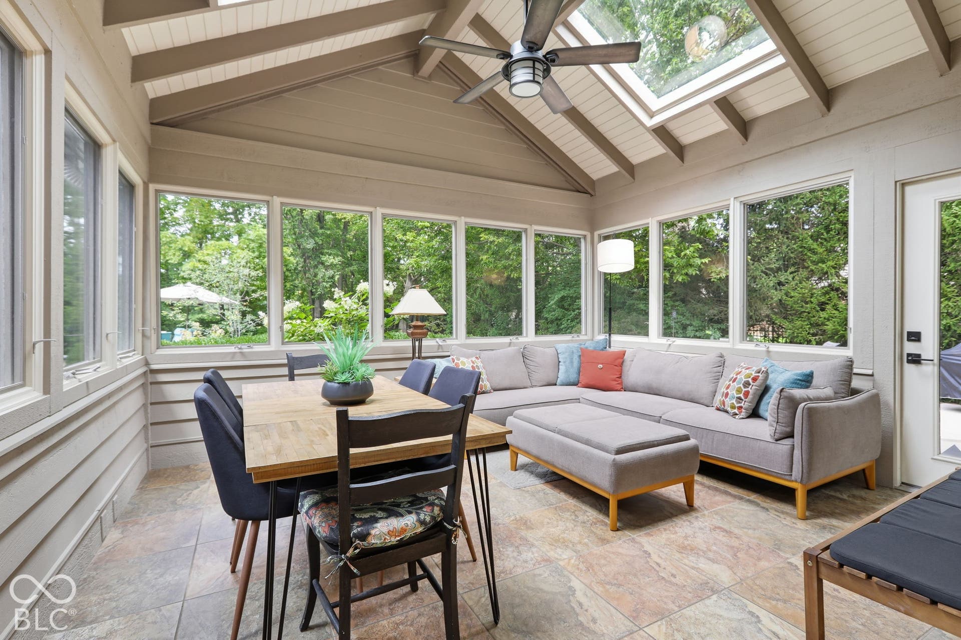 Glass enclosed Screen Porch with Custom Casement window and Skylights