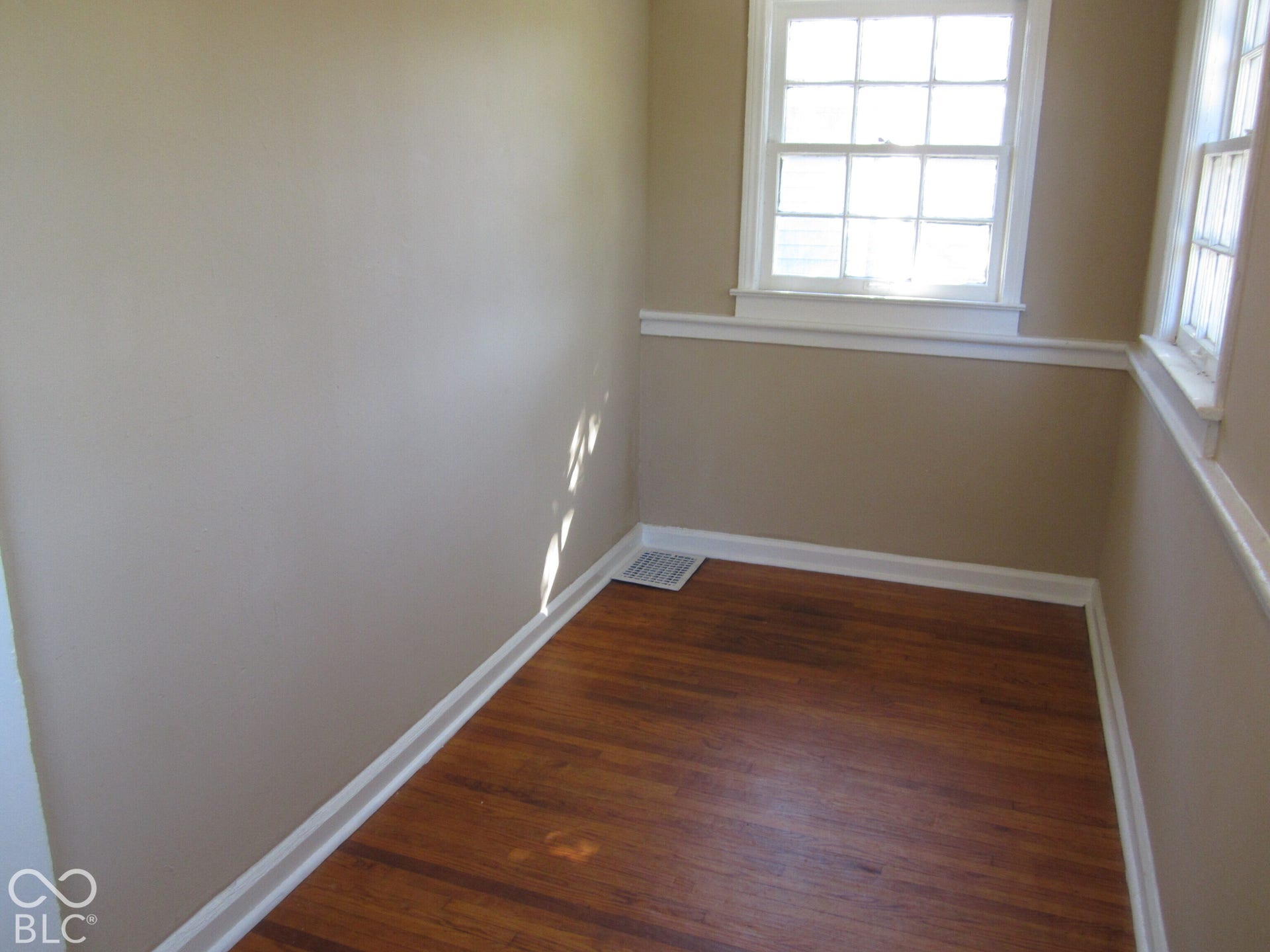 Wood-finish flooring, multi-pane windows, and white chair rail molding