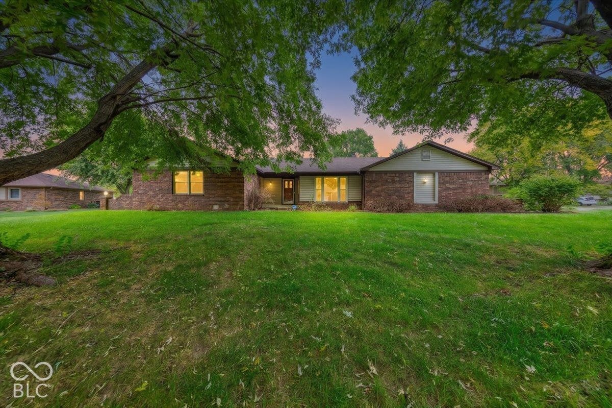 Virtually Altered - Single-story brick exterior featuring a low-pitched roofline, horizontal siding accents, and a front-facing bay window