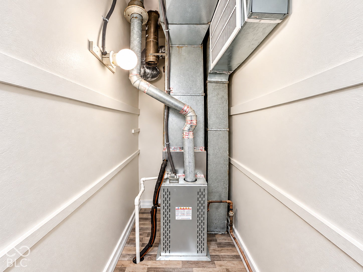 Forced-air furnace system with integrated metal ductwork and wood-finish flooring