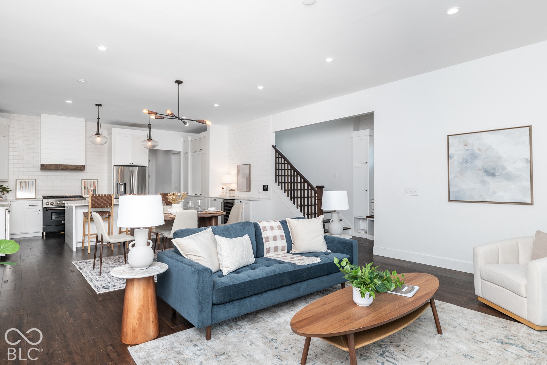 1401 Olive Street, Indianapolis, IN 46203 Open-concept interior featuring wood-finish flooring, recessed lighting, and a modern kitchen with a custom range hood
