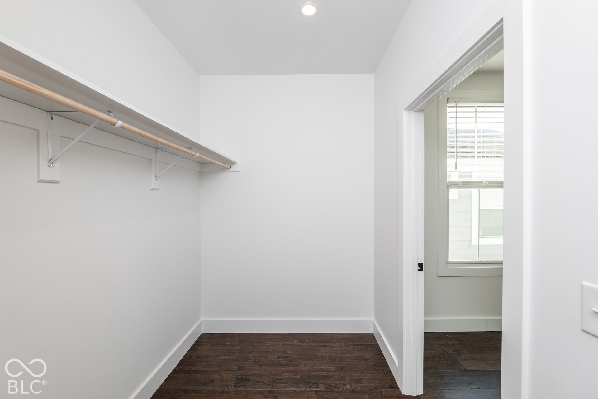 1401 Olive Street, Indianapolis, IN 46203 Walk-in closet featuring wood-finish flooring, recessed lighting, and wall-mounted shelving with a built-in hanging rod