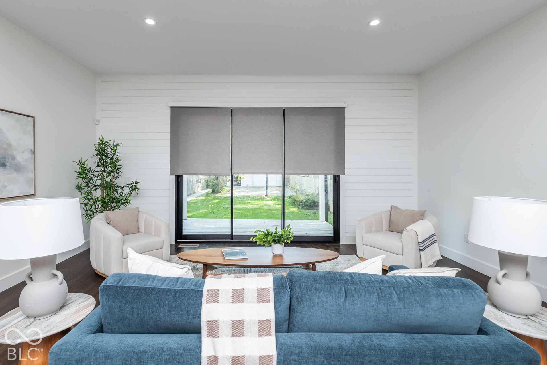 1401 Olive Street, Indianapolis, IN 46203 Living area featuring horizontal shiplap wall paneling, dark wood-finish flooring, recessed lighting, and a large multi-panel sliding glass door